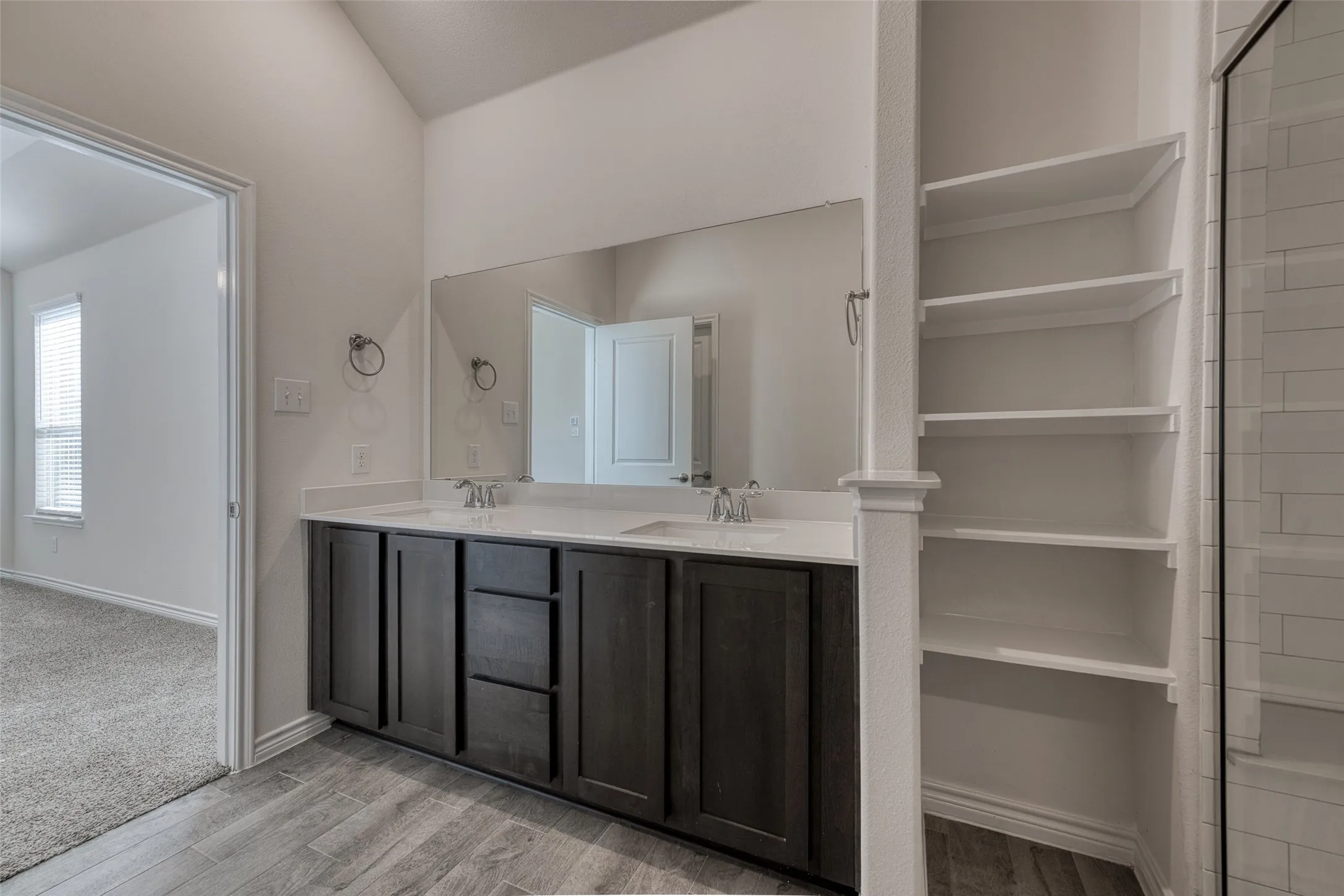 Bathroom with double vanity and light wood-style floors