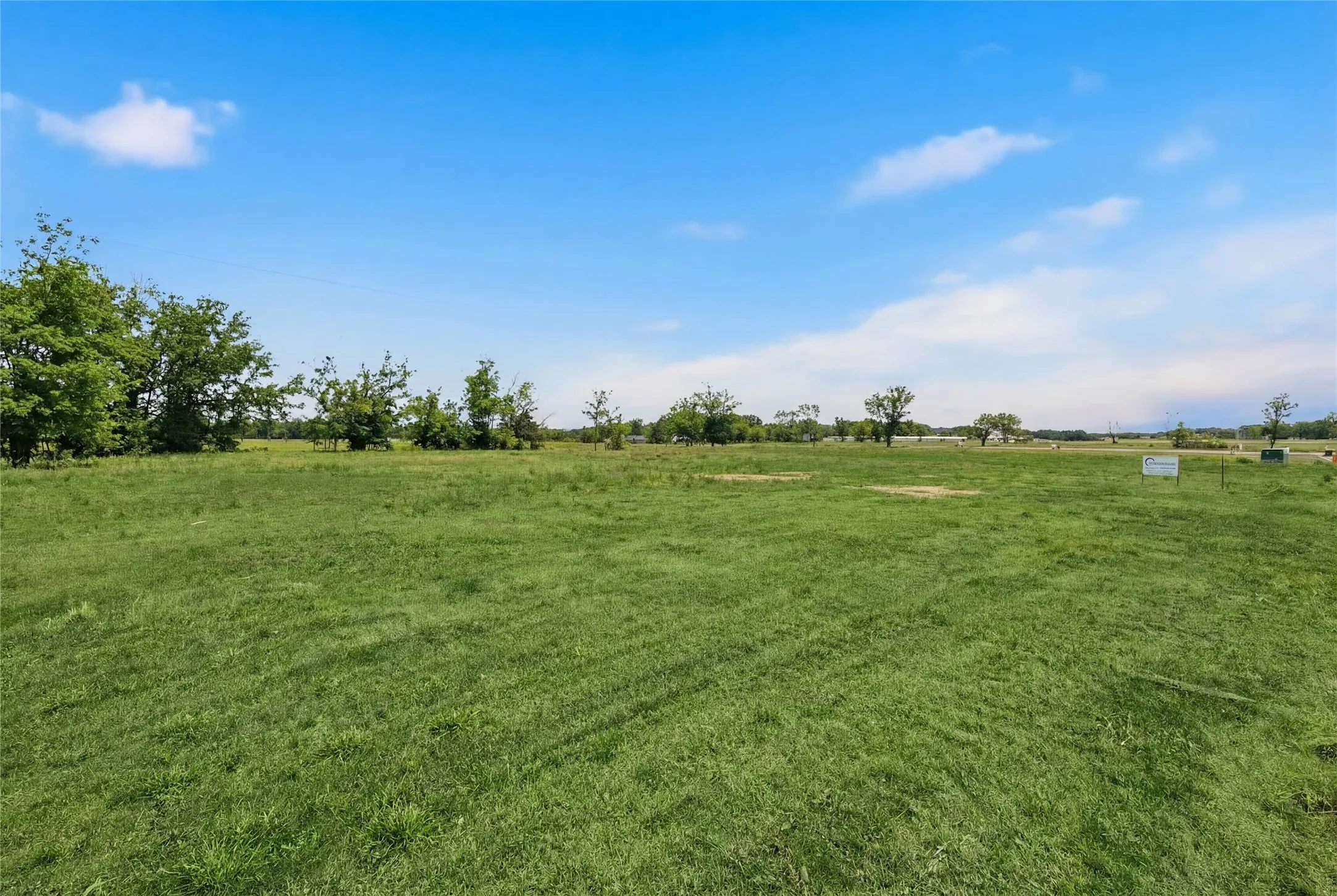This is a photograph of Lot 2 Block G and was captured in February. It has been digitally enhanced to emphasize the presence of leaves and grass.