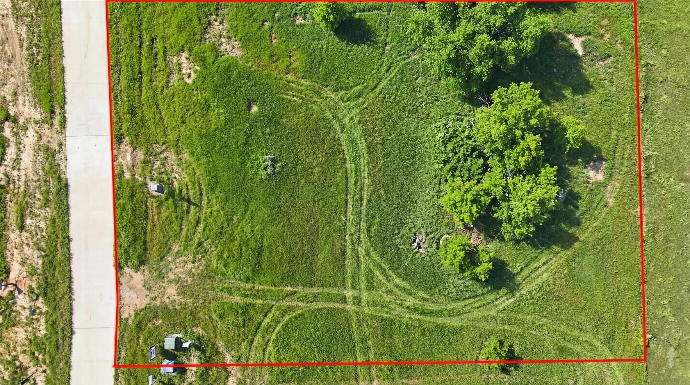 This is an aerial photograph of Lot 2 Block G and was captured in February. It has been digitally enhanced to emphasize the presence of leaves and grass.