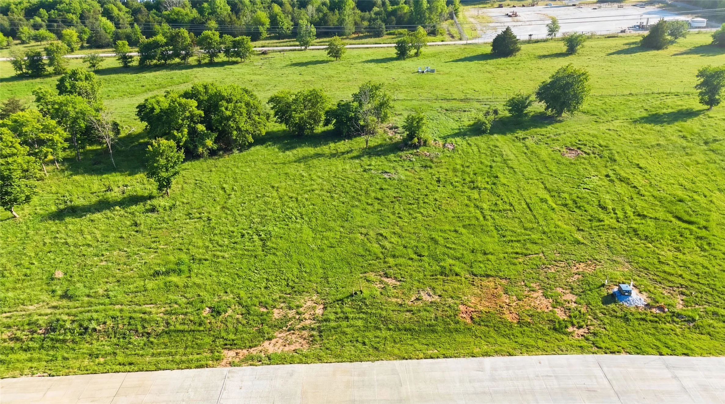This is an aerial photograph of Lot 2 Block G and was captured in February. It has been digitally enhanced to emphasize the presence of leaves and grass.