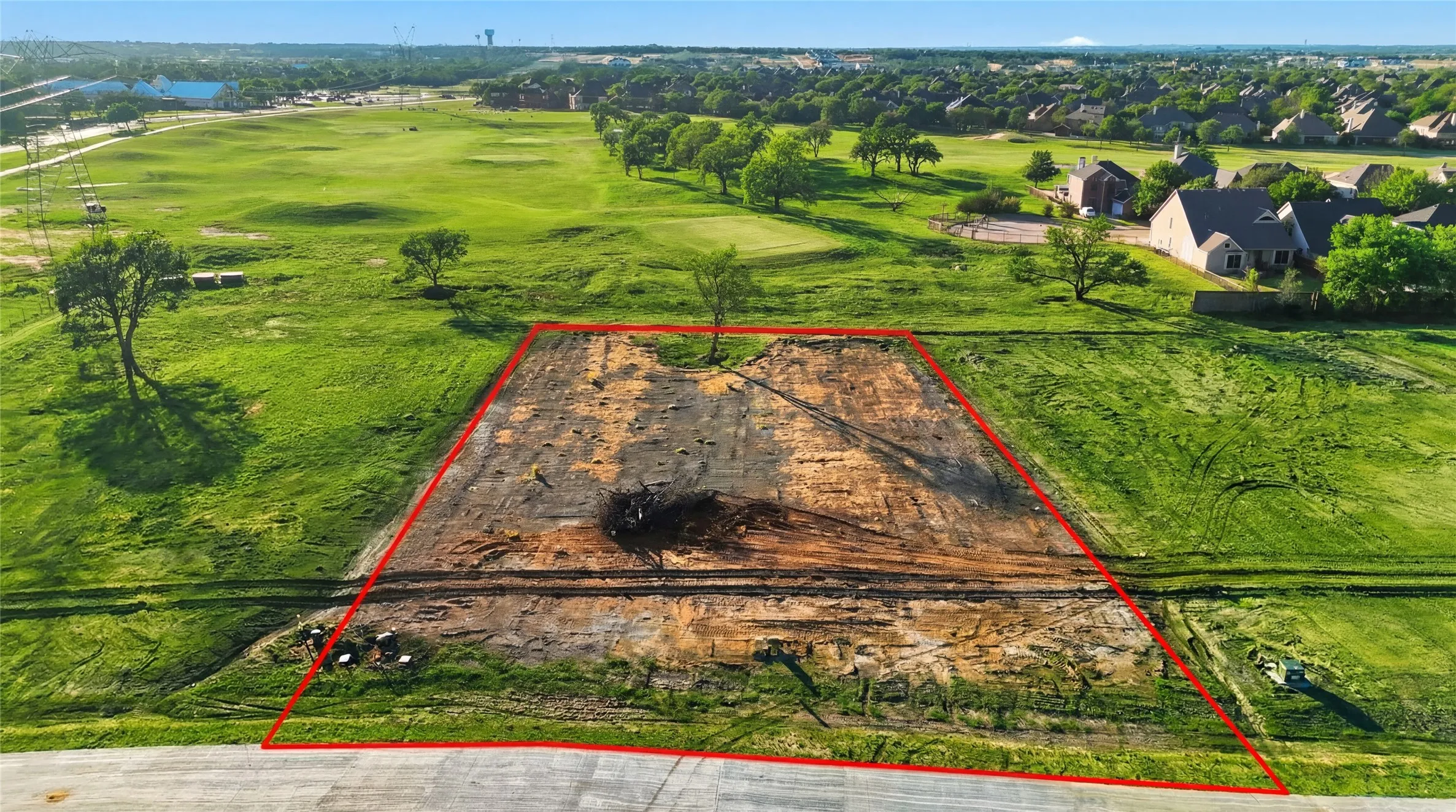 This is an aerial photograph of Lot 2 Block H and was captured in February. It has been digitally enhanced to emphasize the presence of leaves and grass.