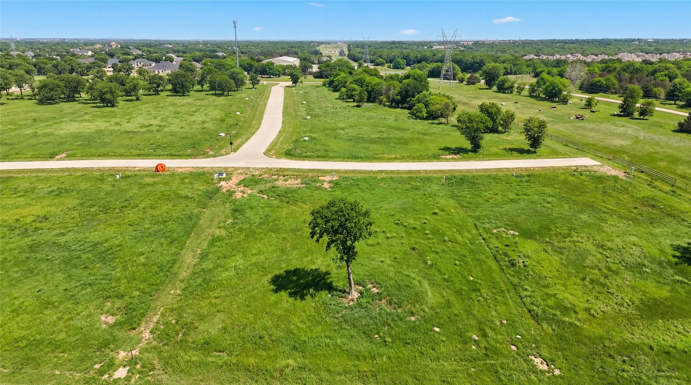 This is an aerial photograph of Lot 2 Block H and was captured in February. It has been digitally enhanced to emphasize the presence of leaves and grass.