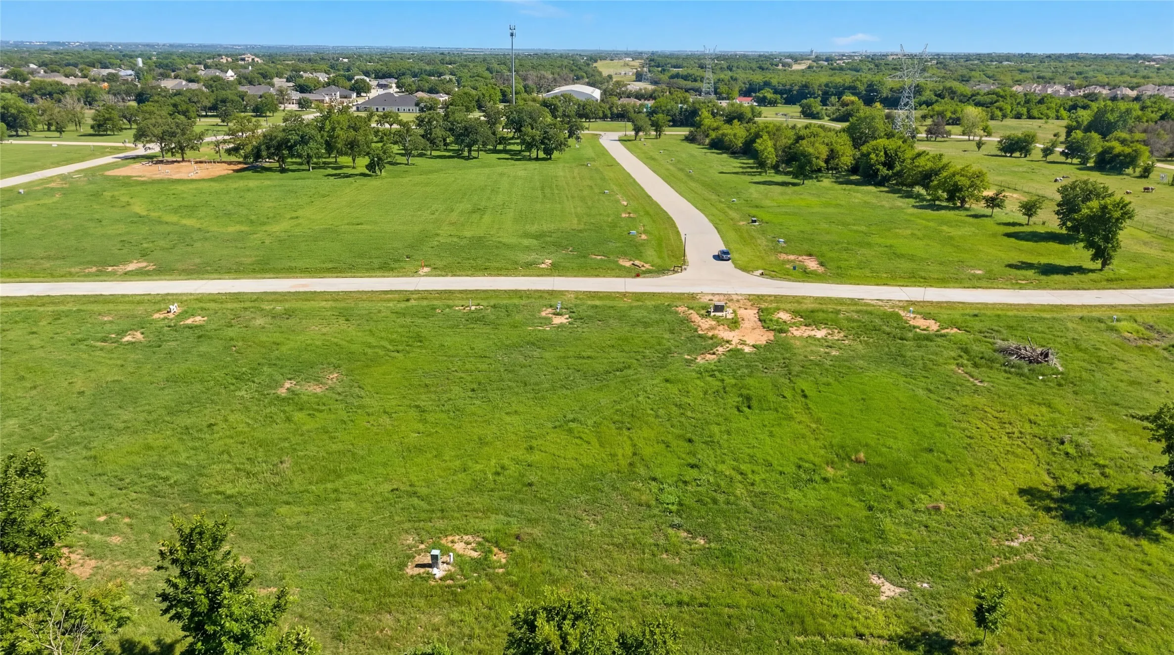 This is an aerial photograph of Lot 3 Block H and was captured in February. It has been digitally enhanced to emphasize the presence of leaves and grass.