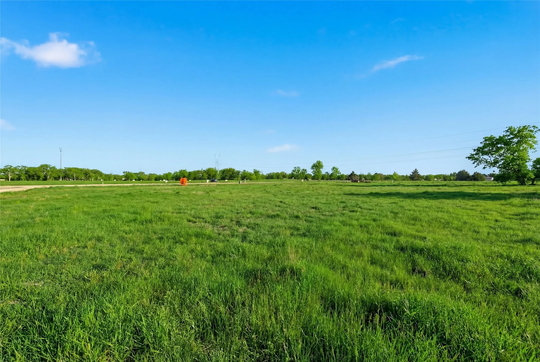This is a photograph of Lot 3 Block H and was captured in February. It has been digitally enhanced to emphasize the presence of leaves and grass.