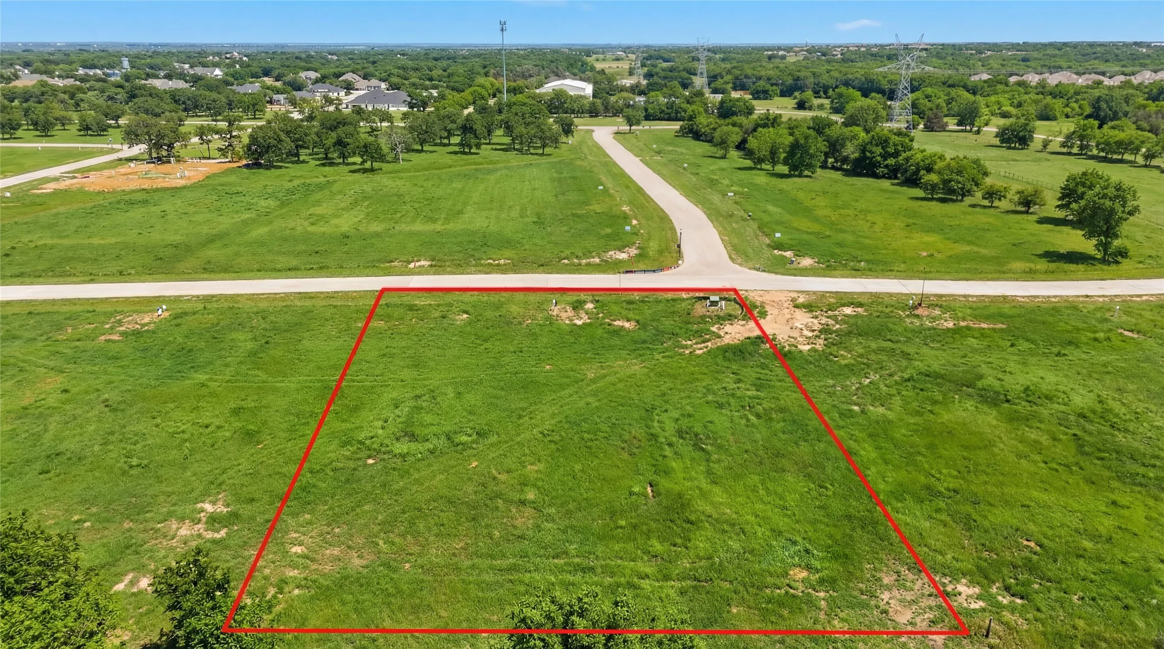 This is an aerial photograph of Lot 3 Block H and was captured in February. It has been digitally enhanced to emphasize the presence of leaves and grass.