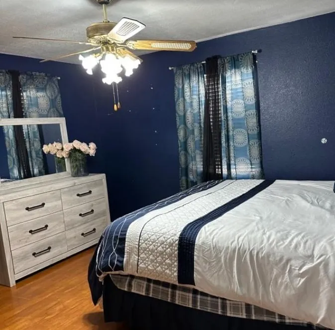 Bedroom featuring a ceiling fan and wood finished floors