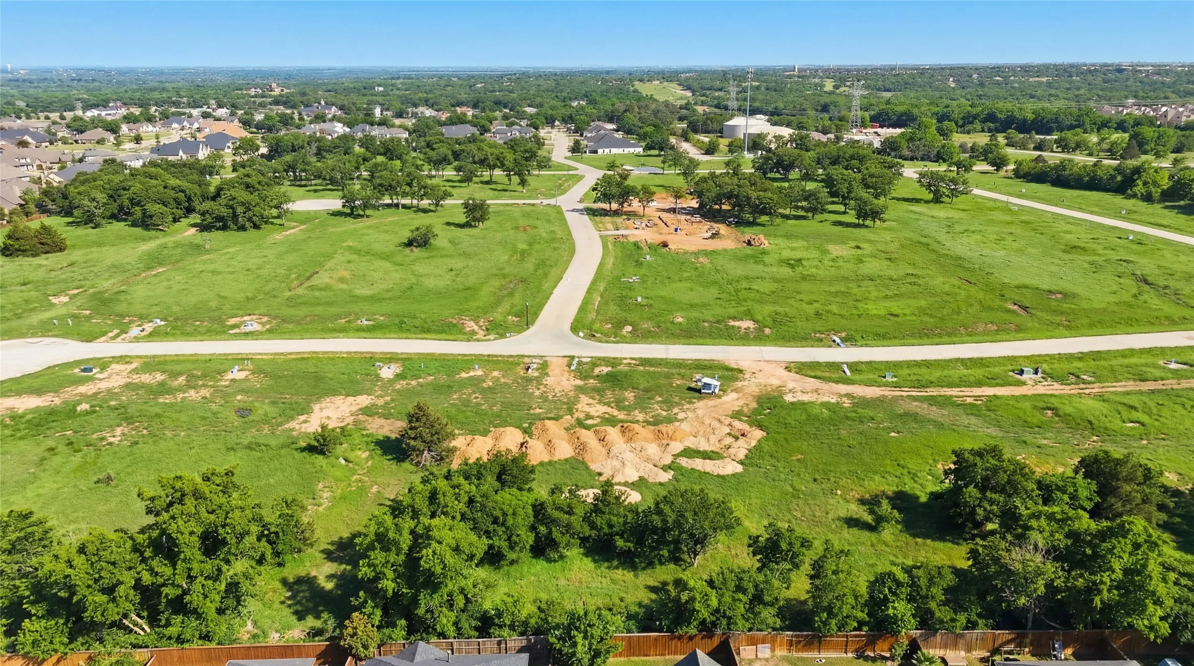 This is an aerial photograph of Lot 6 Block H and was captured in February. It has been digitally enhanced to emphasize the presence of leaves and grass.
