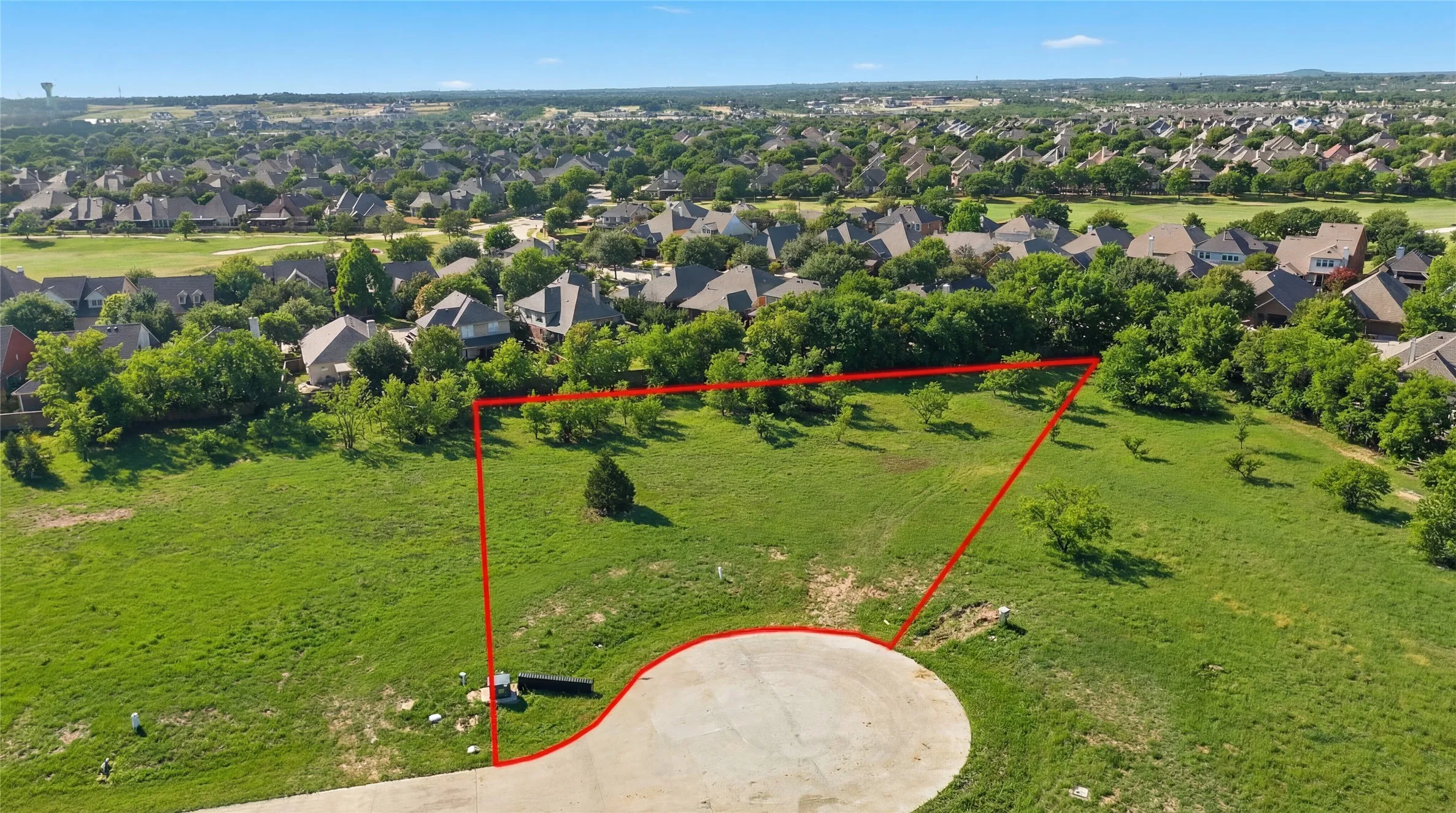 This is an aerial photograph of Lot 8 Block H and was captured in February. It has been digitally enhanced to emphasize the presence of leaves and grass.