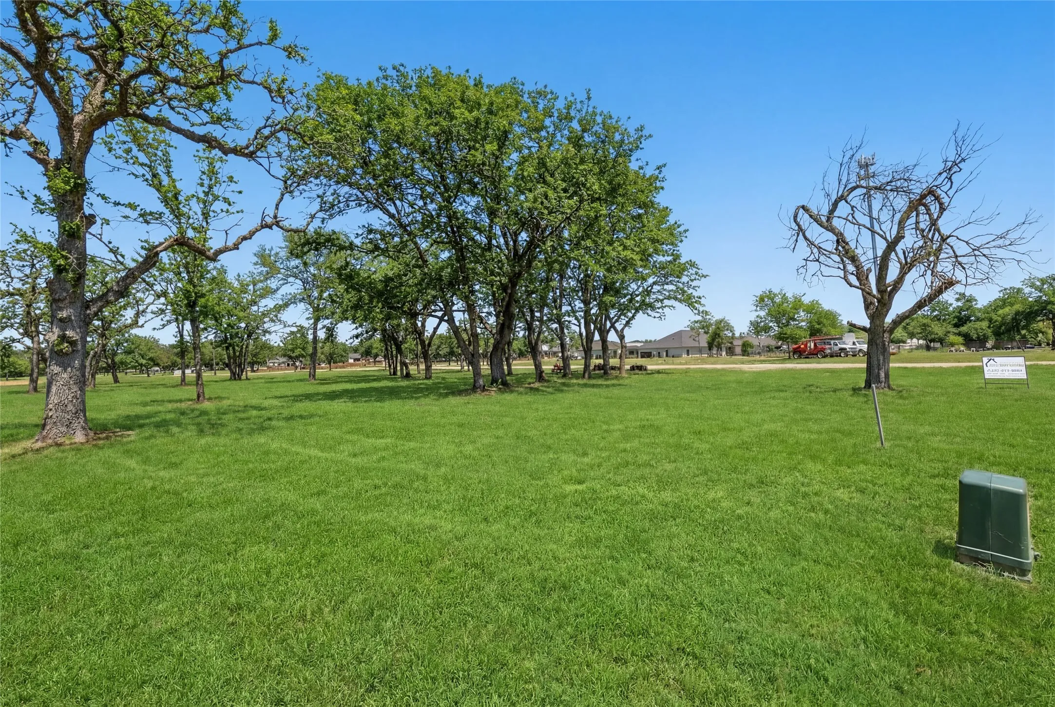 This is a photograph of Lot 6 Block J and was captured in February. It has been digitally enhanced to emphasize the presence of leaves and grass.