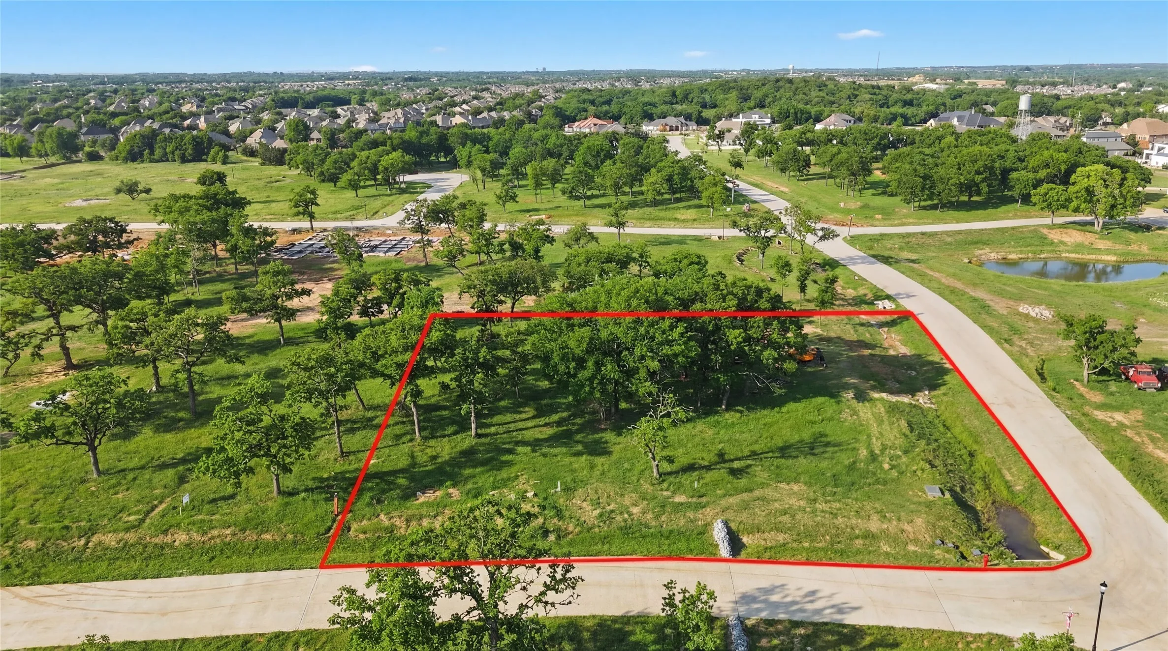 This is an aerial photograph of Lot 6 Block J and was captured in February. It has been digitally enhanced to emphasize the presence of leaves and grass.
