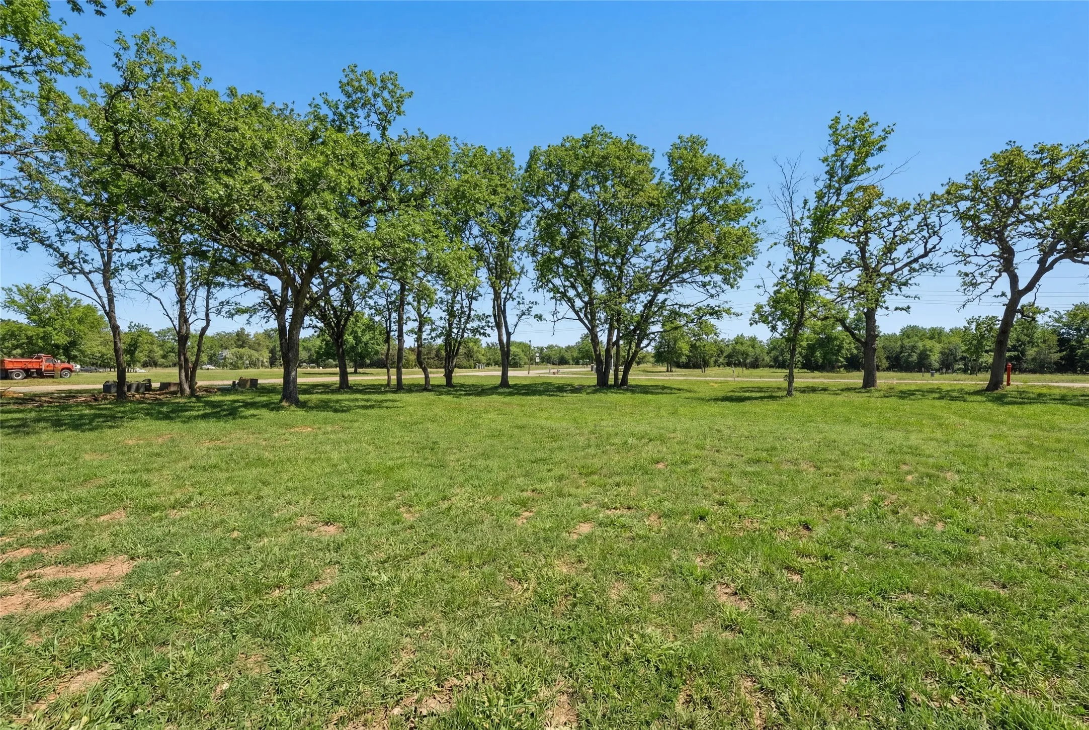 This is a photograph of Lot 6 Block J and was captured in February. It has been digitally enhanced to emphasize the presence of leaves and grass.