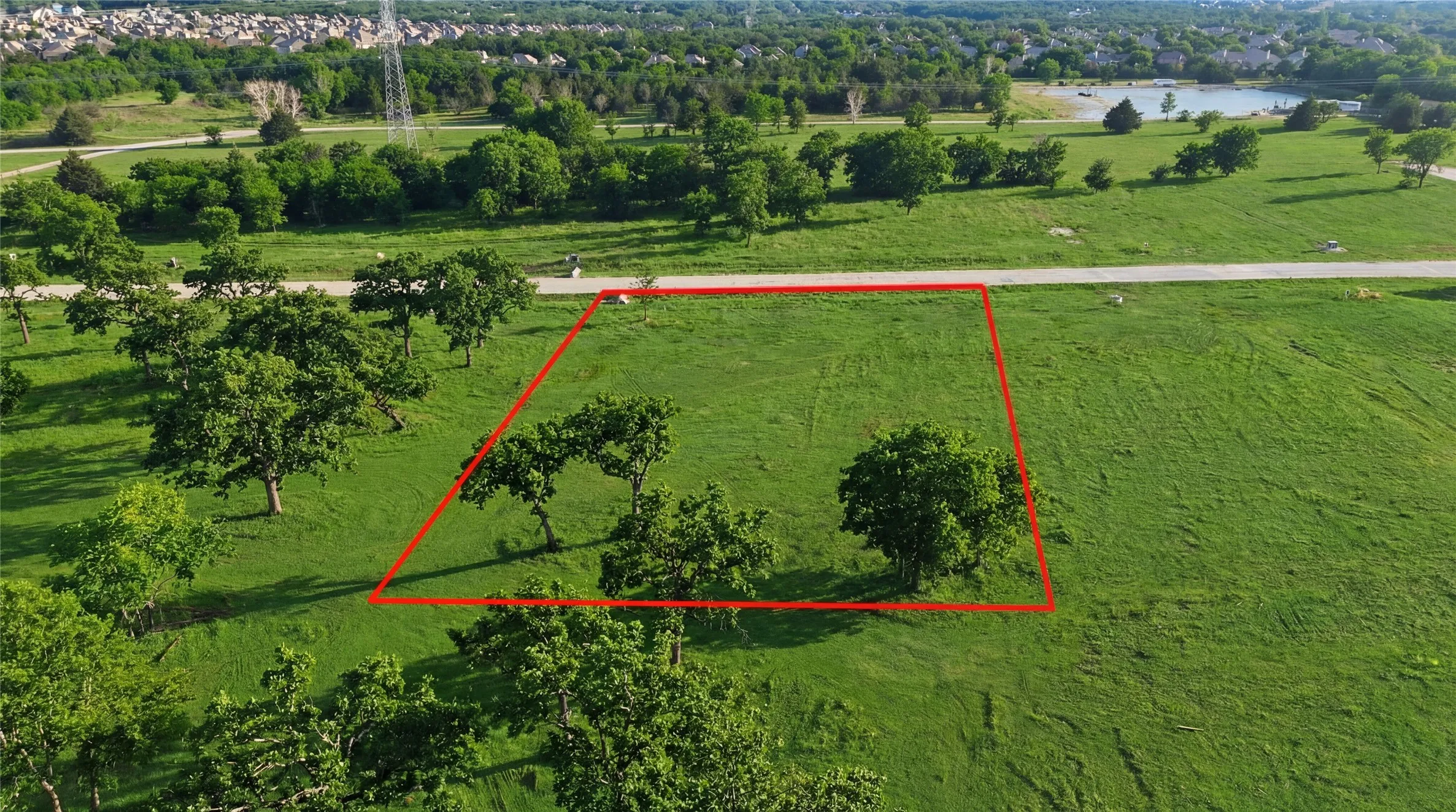 This is an aerial photograph of Lot 8 Block J and was captured in February. It has been digitally enhanced to emphasize the presence of leaves and grass.