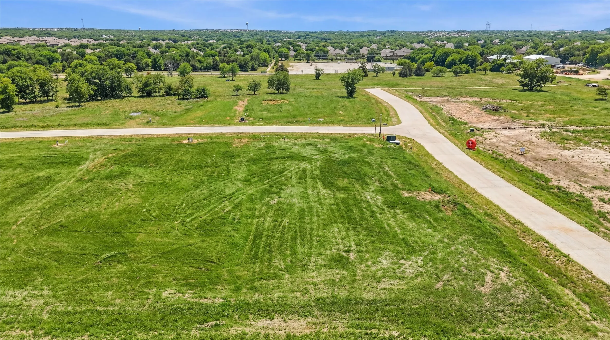 This is an aerial photograph of Lot 10 Block J and was captured in February. It has been digitally enhanced to emphasize the presence of leaves and grass.