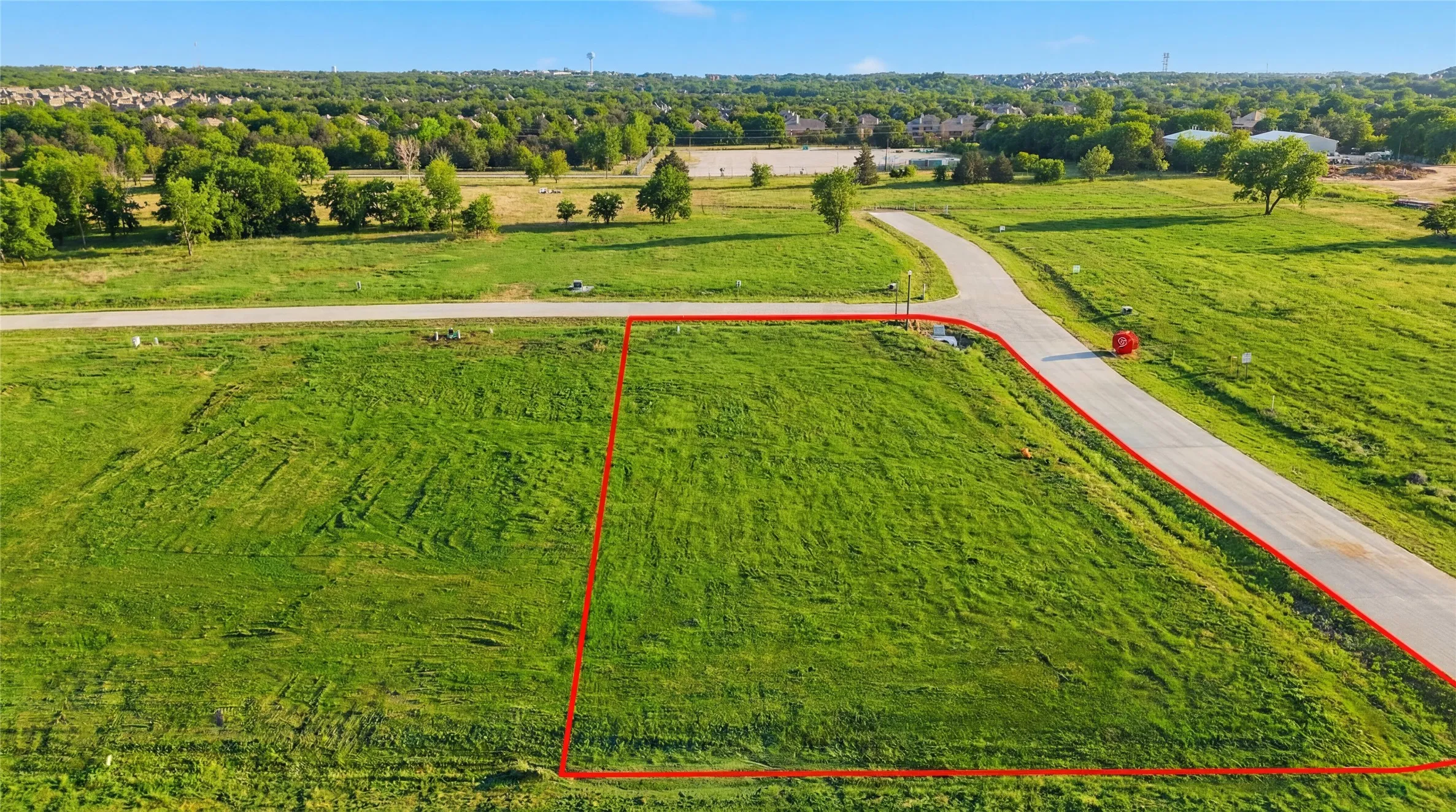 This is an aerial photograph of Lot 10 Block J and was captured in February. It has been digitally enhanced to emphasize the presence of leaves and grass.