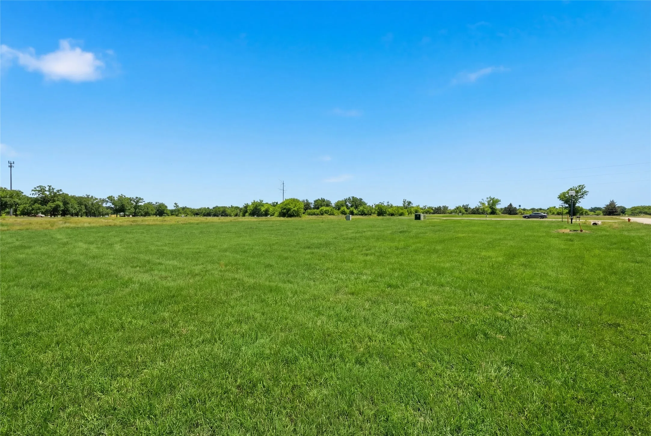 This is a photograph of Lot 10 Block J and was captured in February. It has been digitally enhanced to emphasize the presence of leaves and grass.
