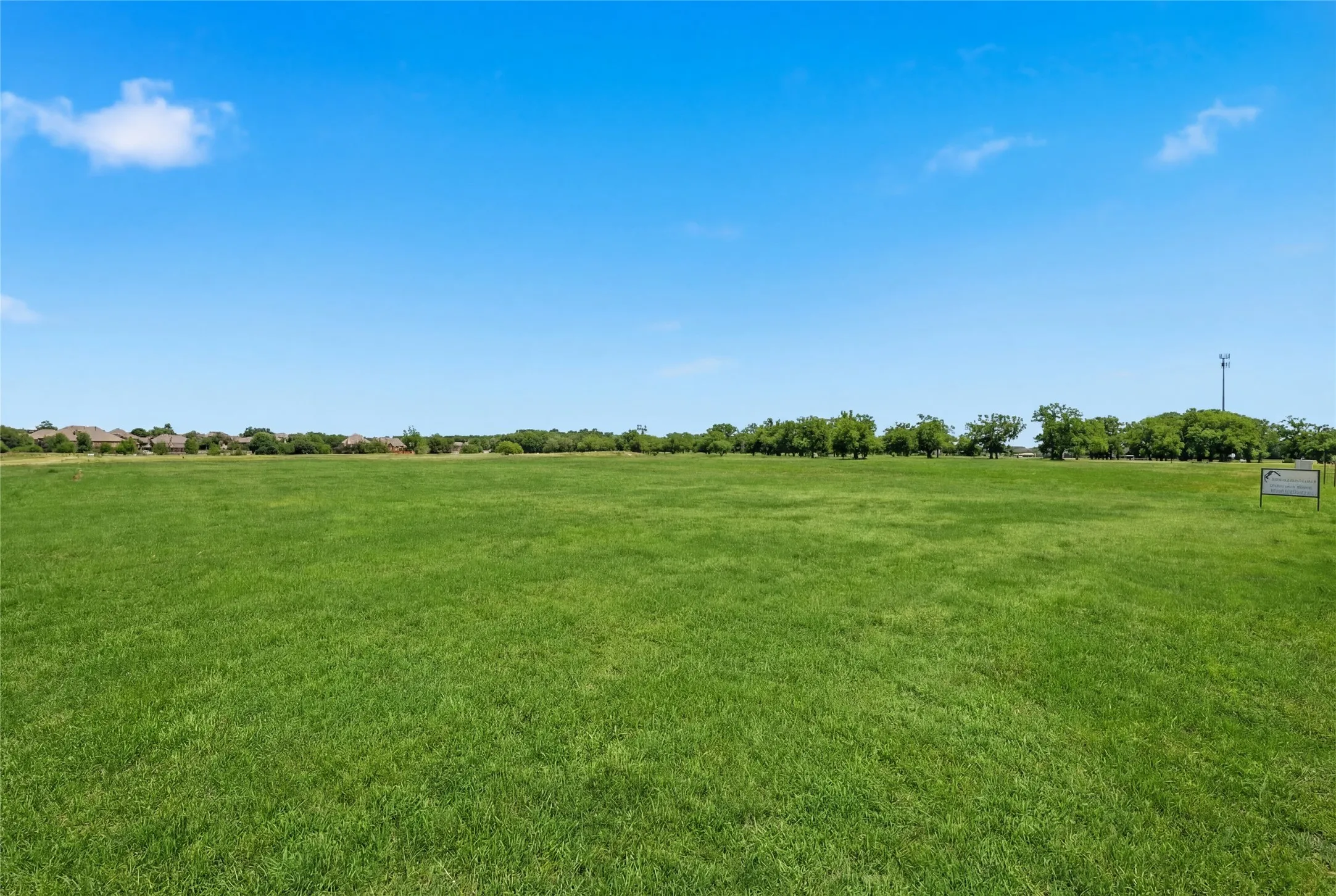 This is a photograph of Lot 10 Block J and was captured in February. It has been digitally enhanced to emphasize the presence of leaves and grass.
