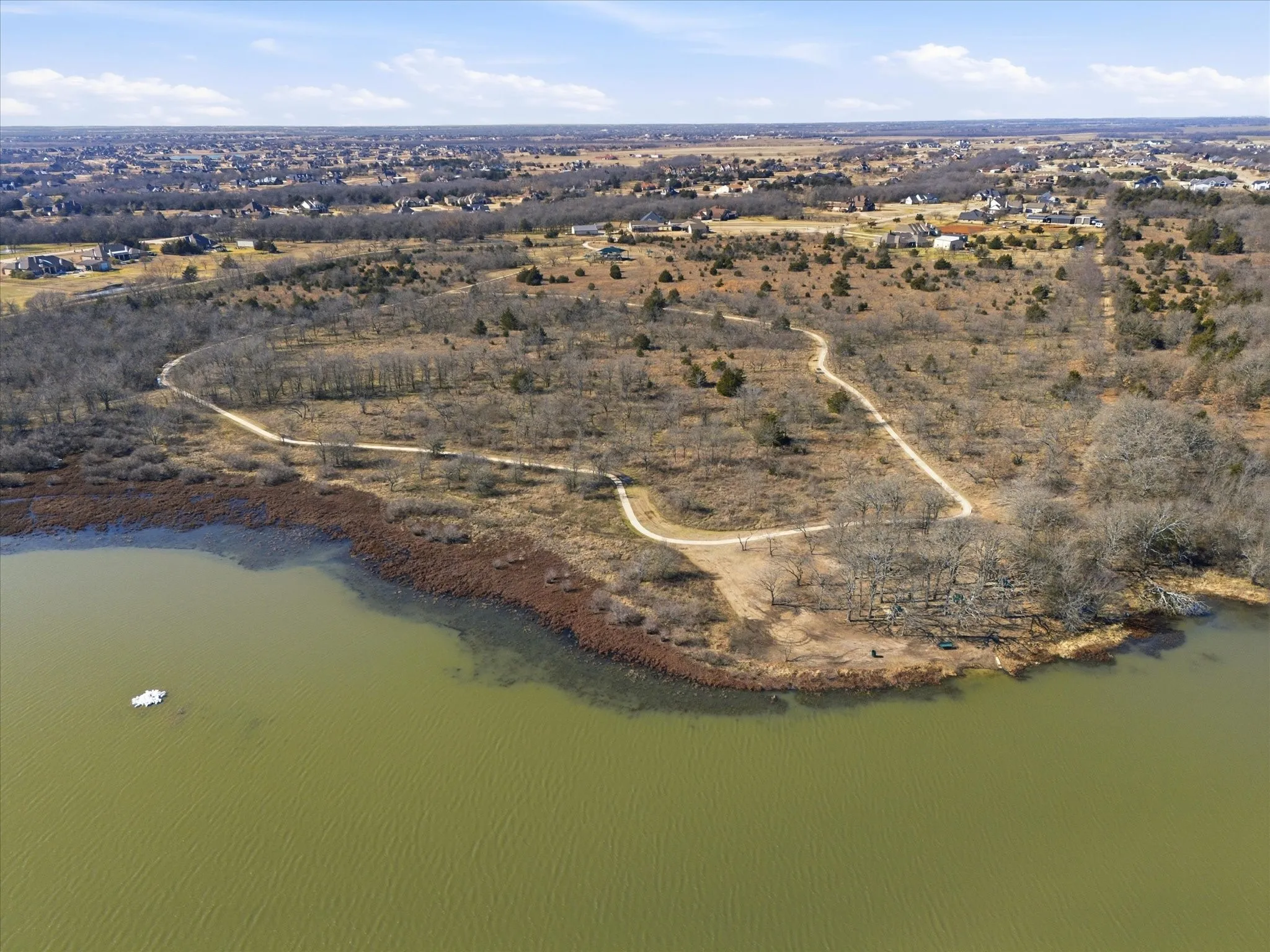Aerial view of property's location featuring a large body of water