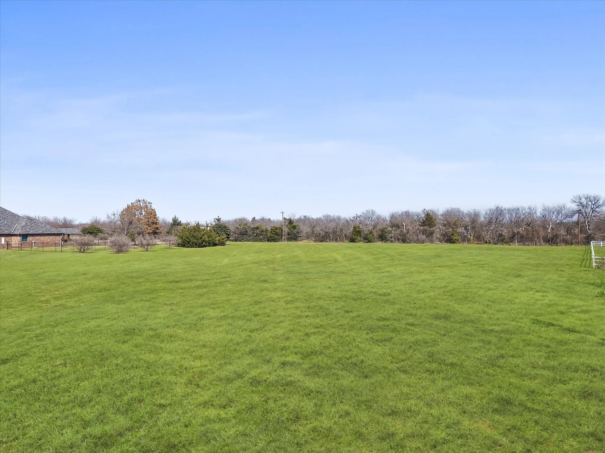 View of green lawn with a view of countryside