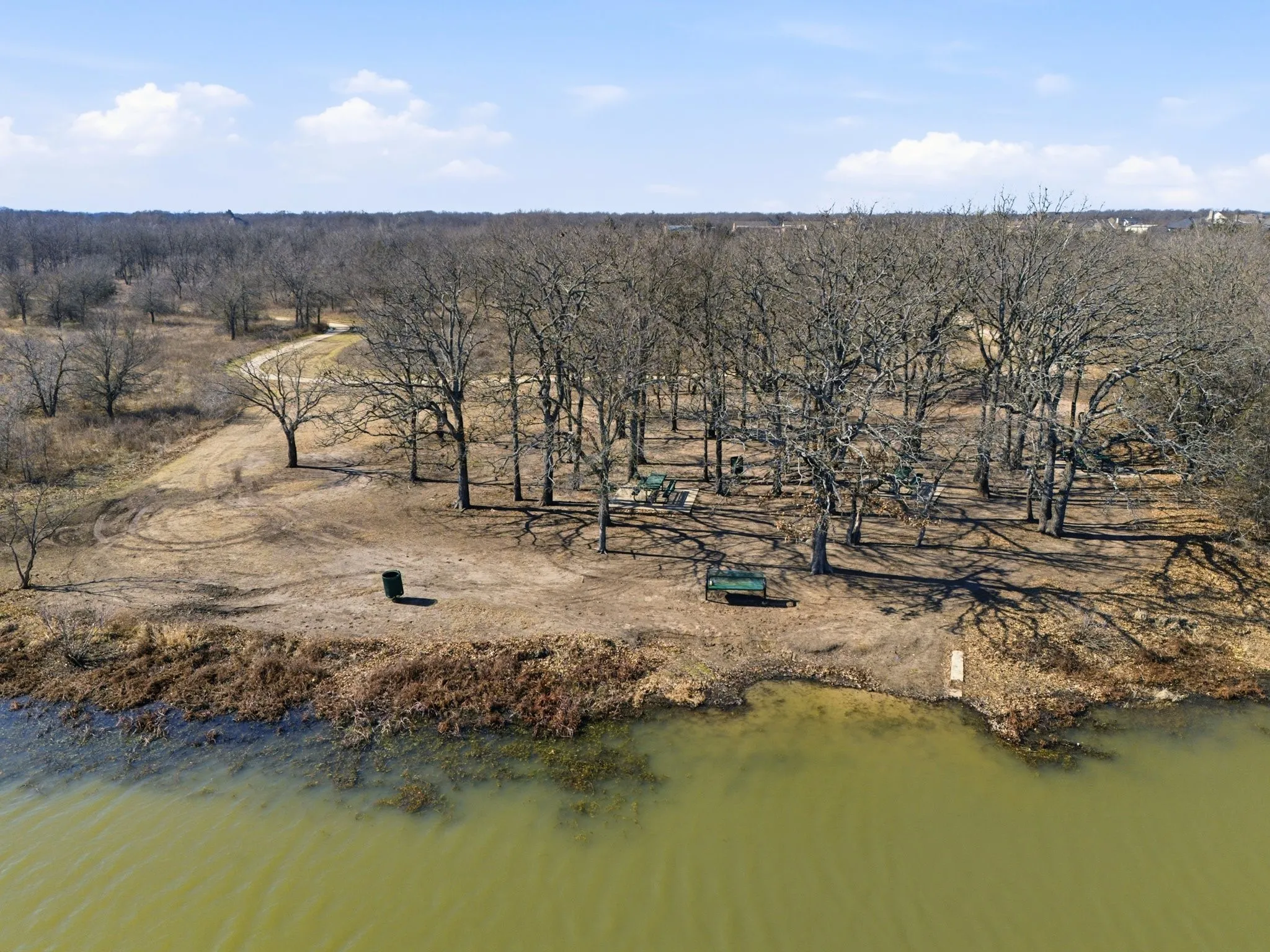 Aerial view of property and surrounding area featuring a large body of water
