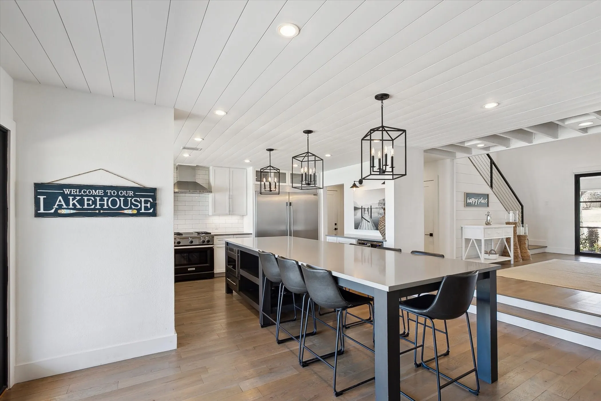 Kitchen featuring light wood floors, light countertops, and high end appliances.
