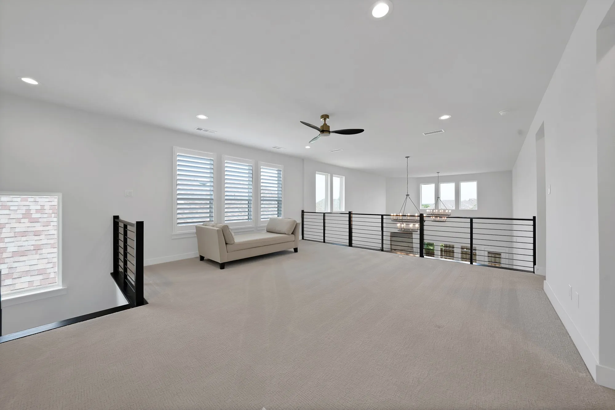 Spacious upper-level loft featuring recessed lighting, a ceiling fan, and light-colored carpeting