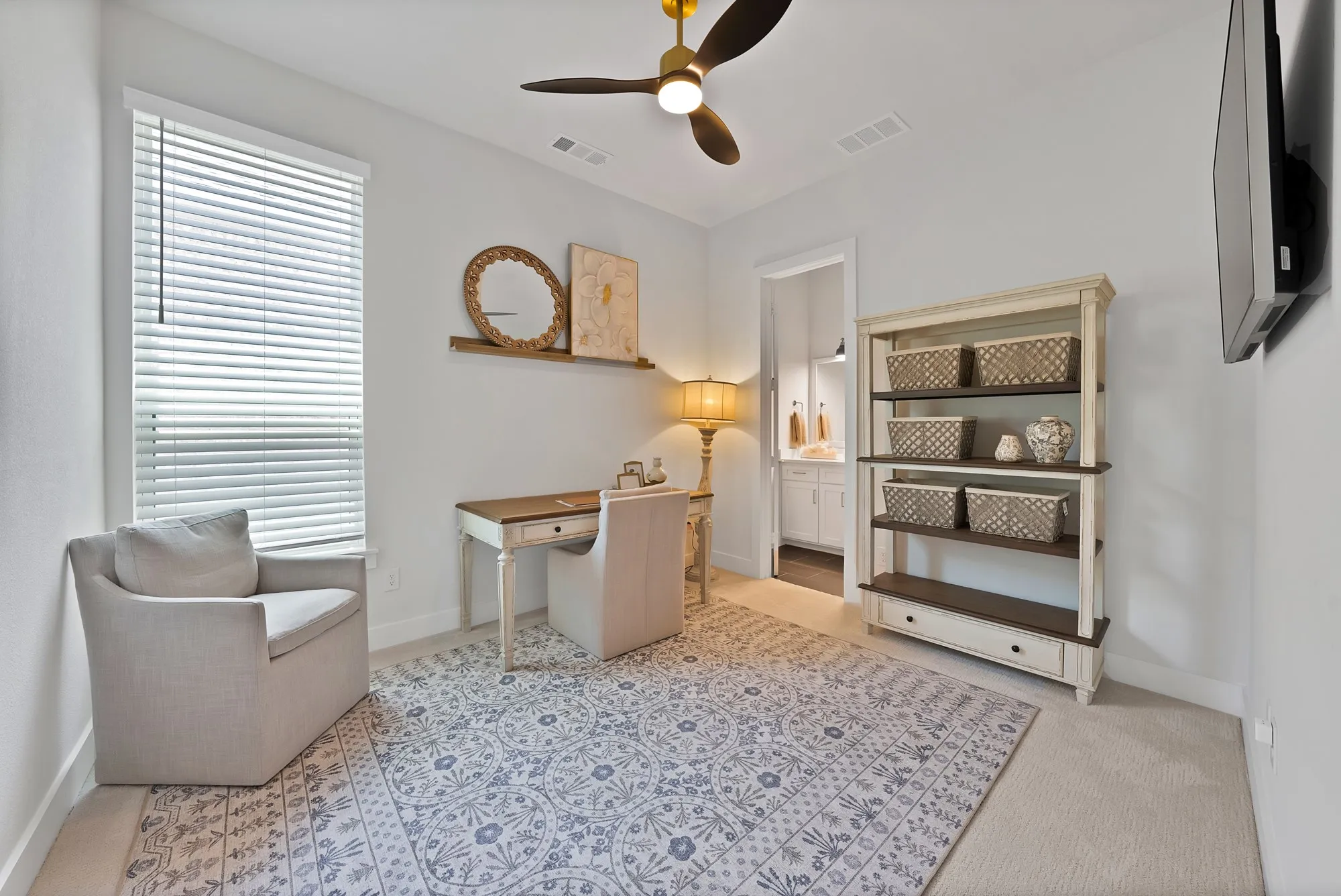 Well-lit interior space featuring neutral wall tones, a ceiling fan with integrated lighting, and a window with horizontal blinds