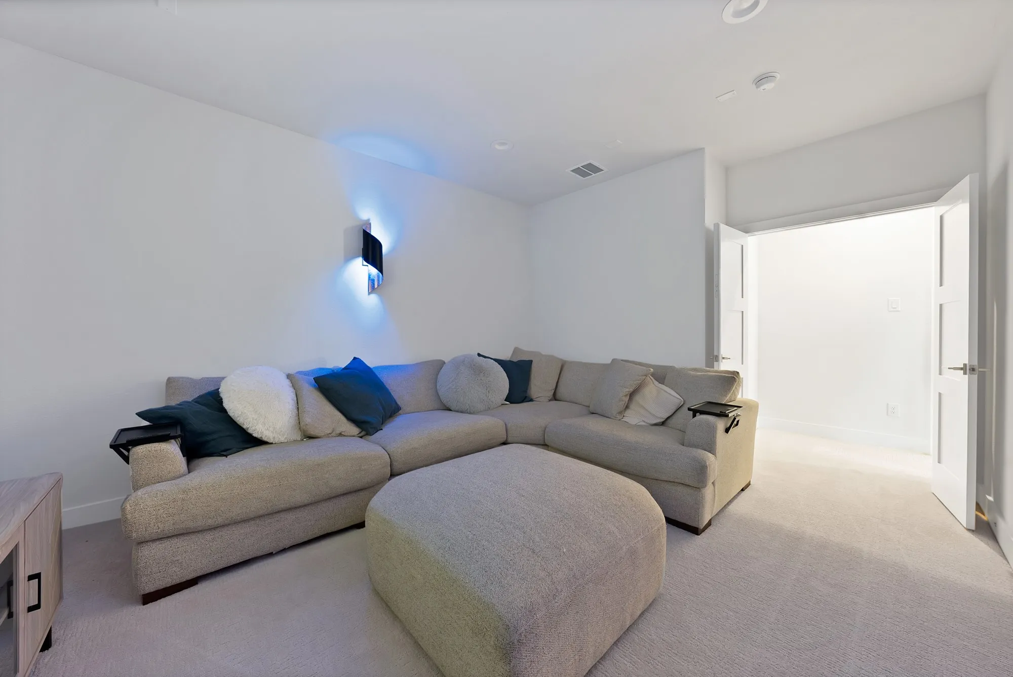 Recessed lighting in a room featuring carpet flooring and white walls