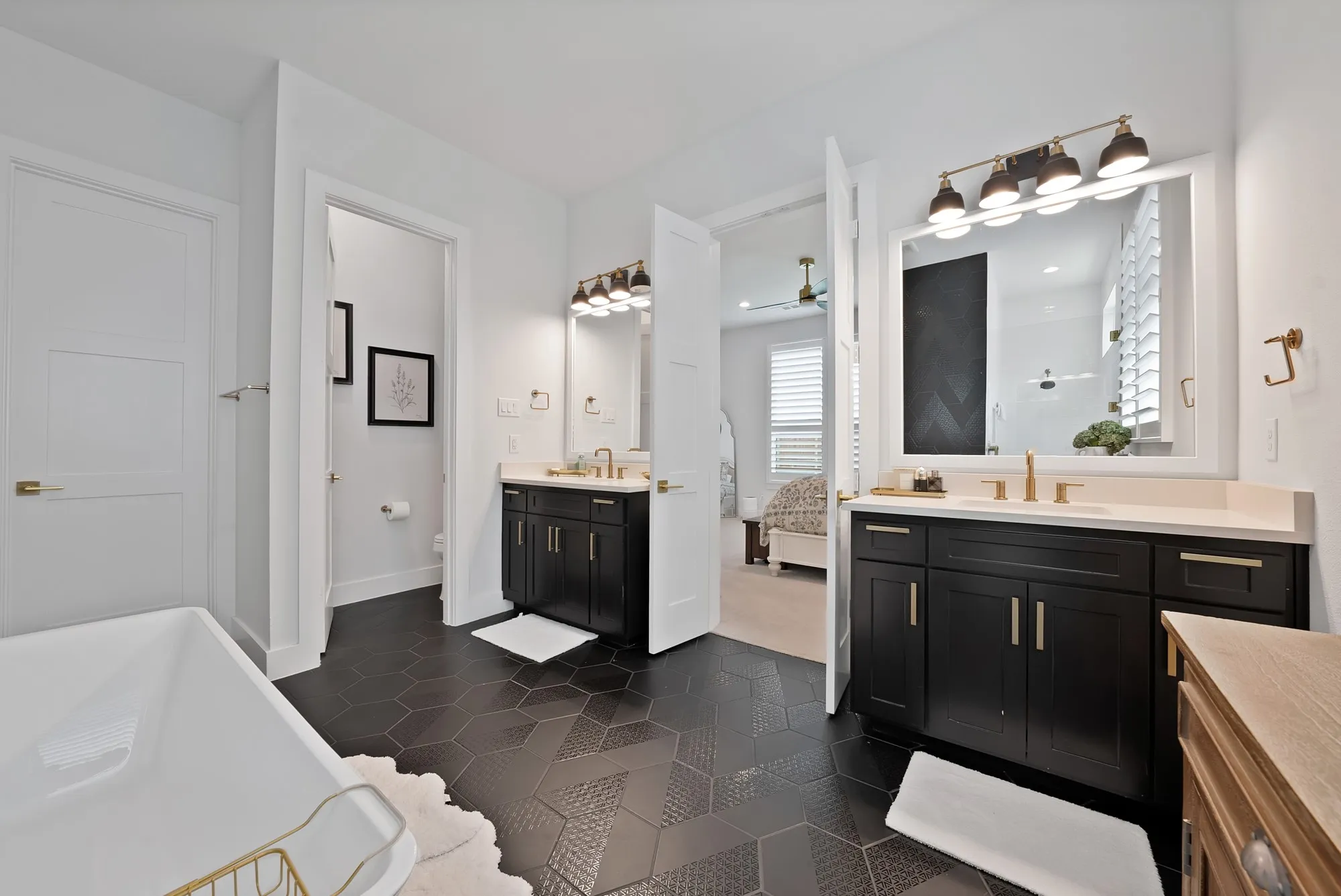 Dual vanities with dark cabinetry and light countertops