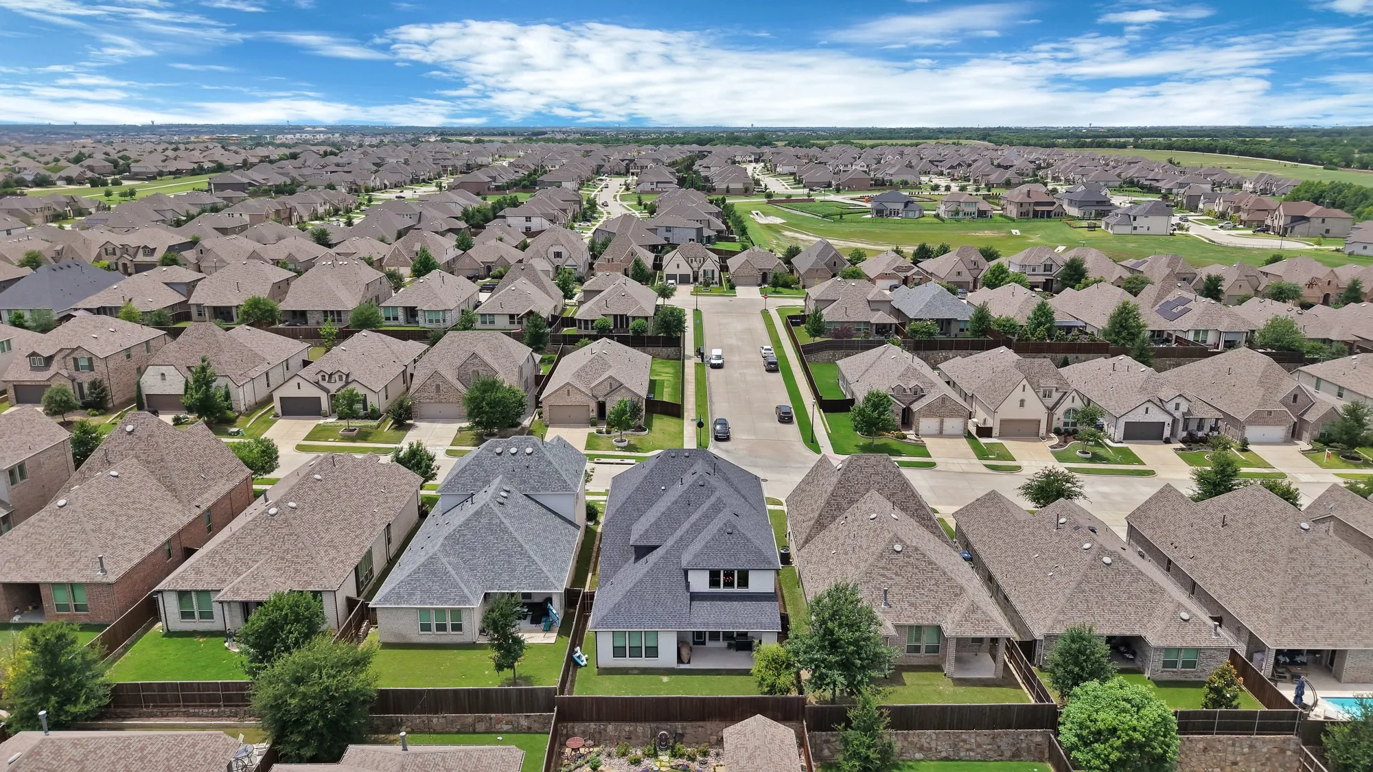 Aerial perspective showcasing a residential development with numerous single-family homes