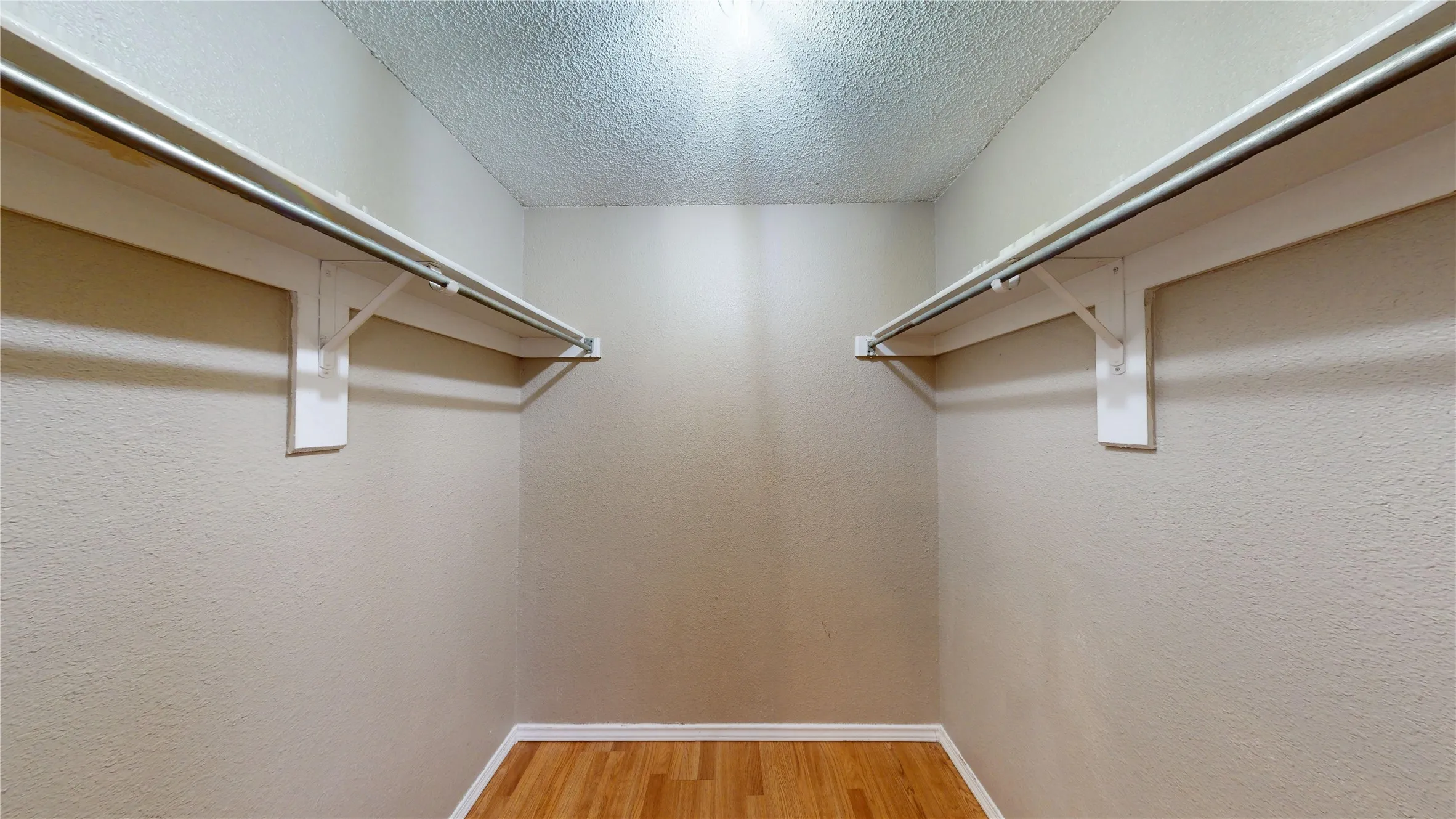 Walk in closet featuring light wood-type flooring