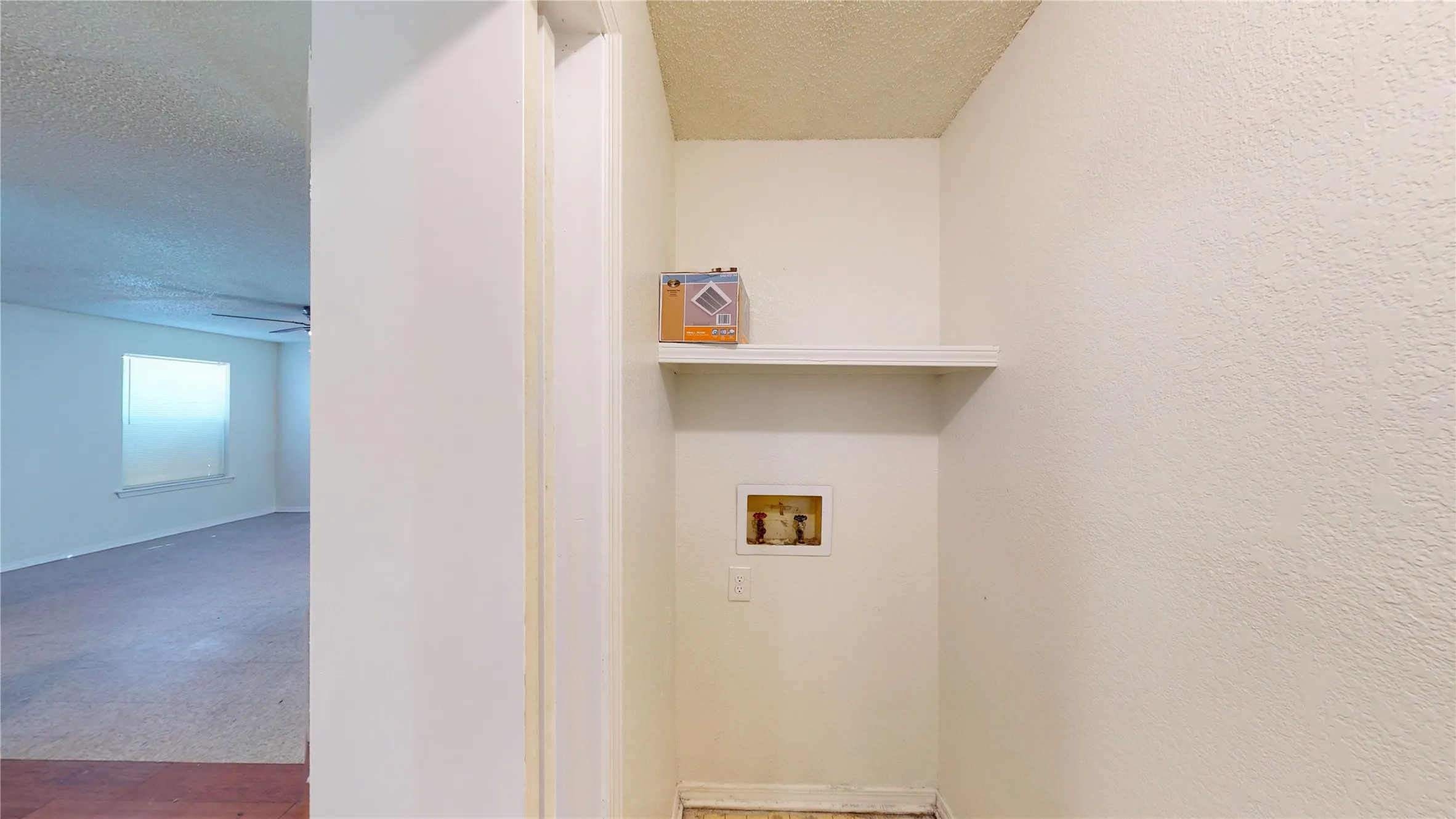 Laundry room featuring a textured ceiling, carpet floors, and washer hookup