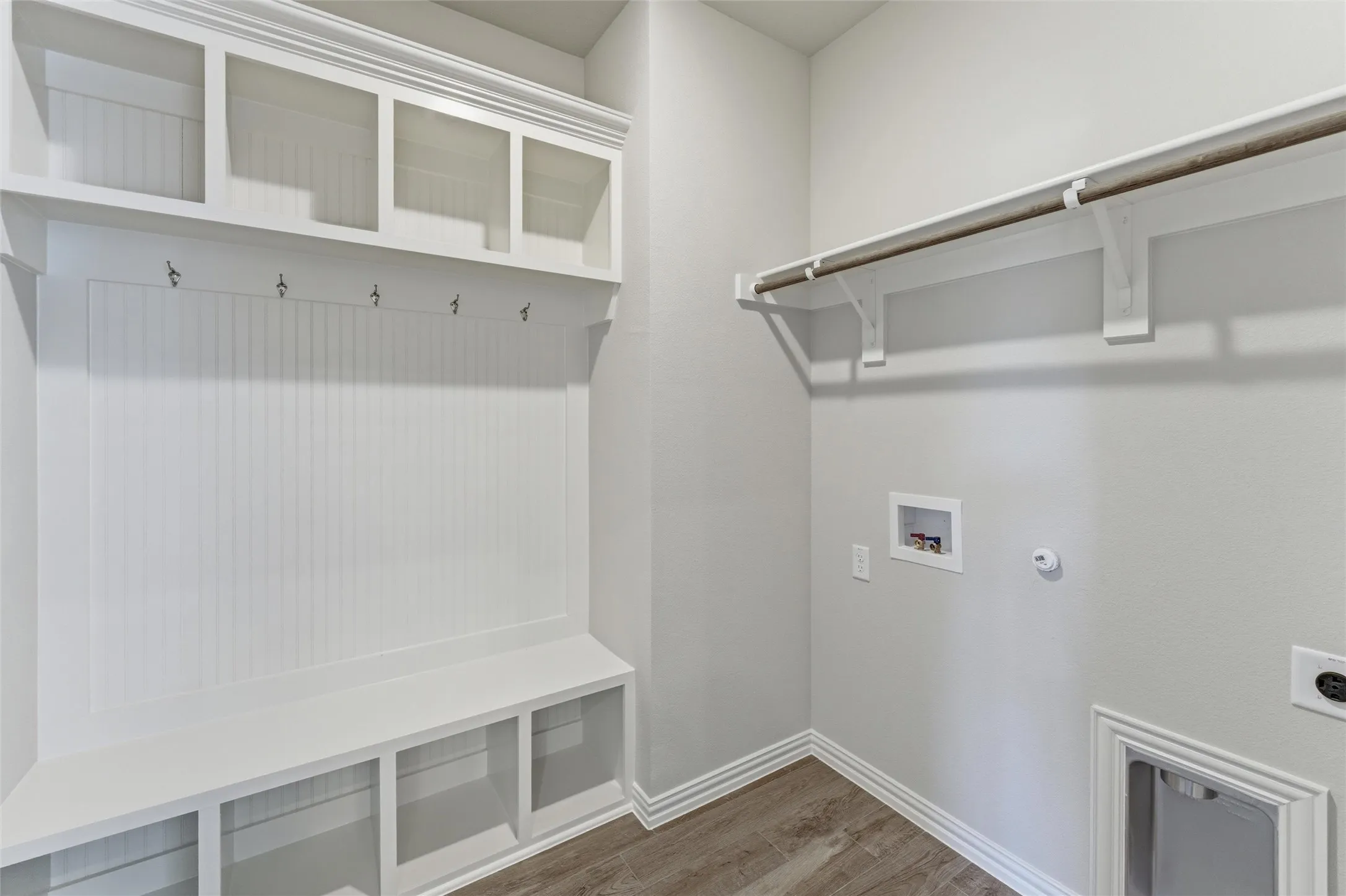 Laundry area with dark wood-style flooring, hookup for a washing machine, hookup for a gas dryer, and hookup for an electric dryer