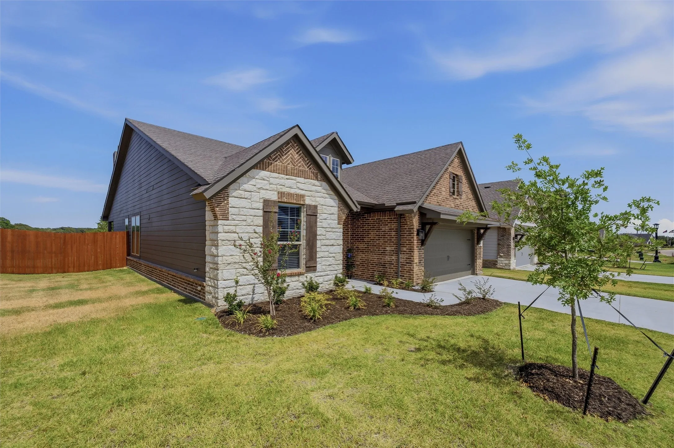 Stone and brick exterior with wood siding accents
