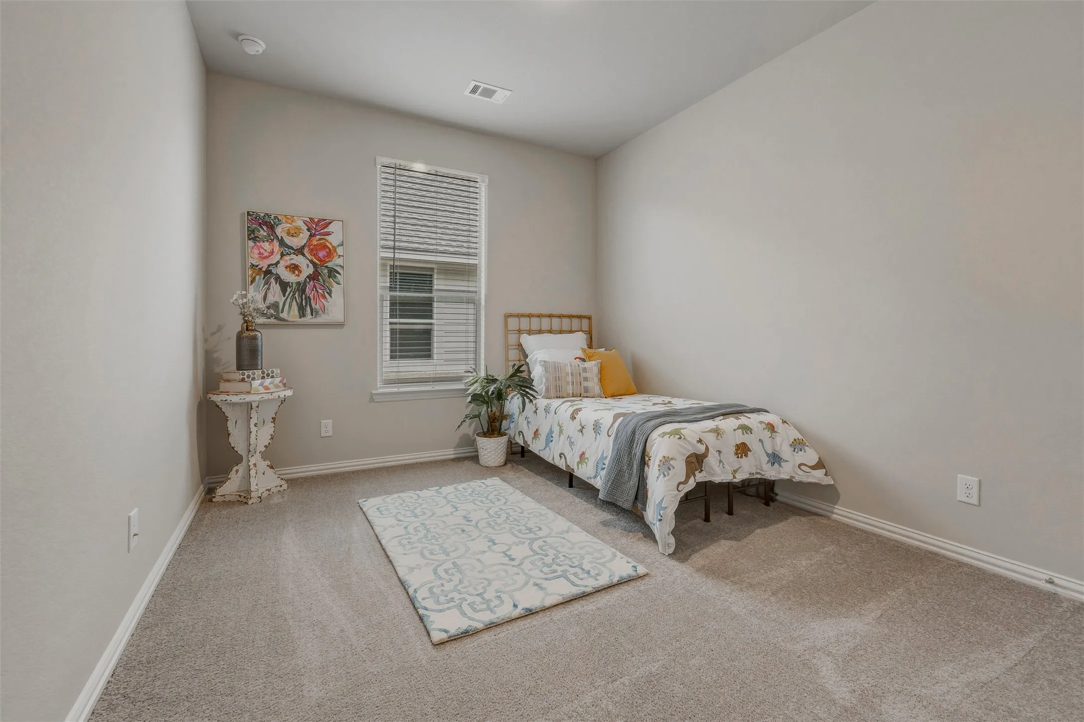Carpeted flooring, vaulted ceiling, single window with blinds, light-toned wall paint, and white trim