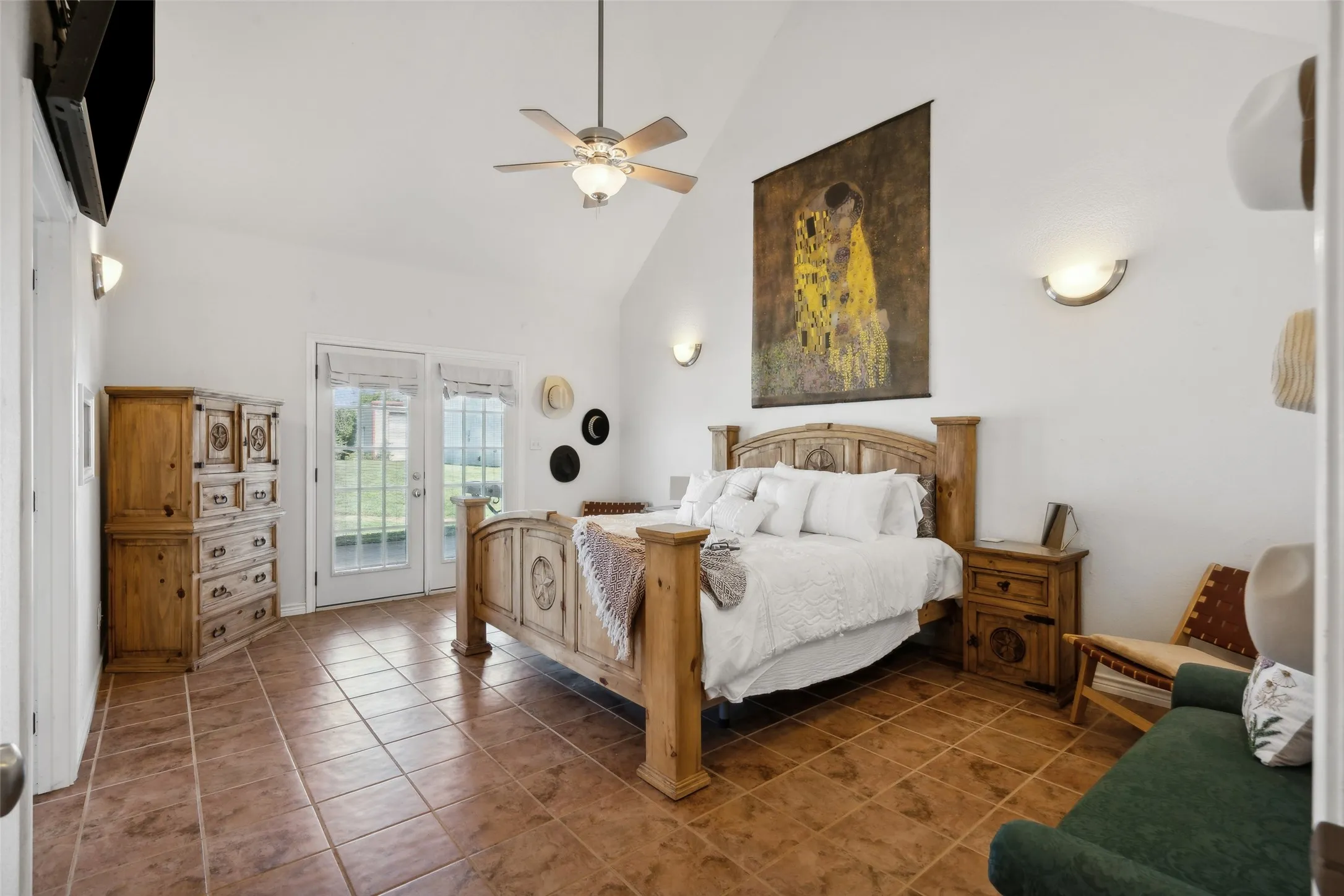 The primary suite with French doors to the outside patio and pool area