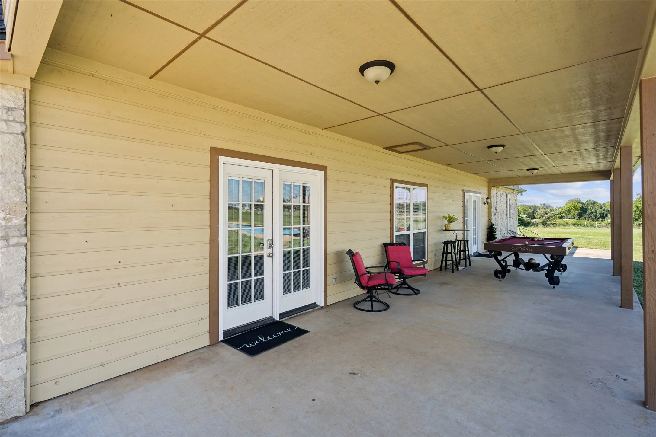 Back porch has front doors to the living and primary suite