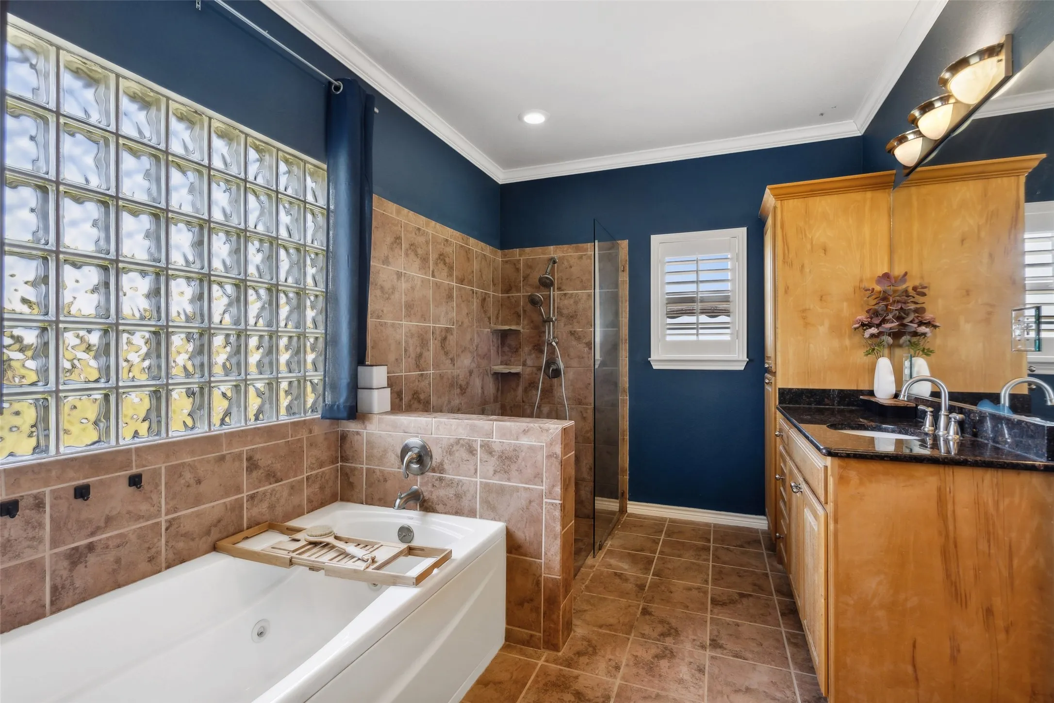 The primary bathroom has a separate shower and bath. It also has two vanities and sinks