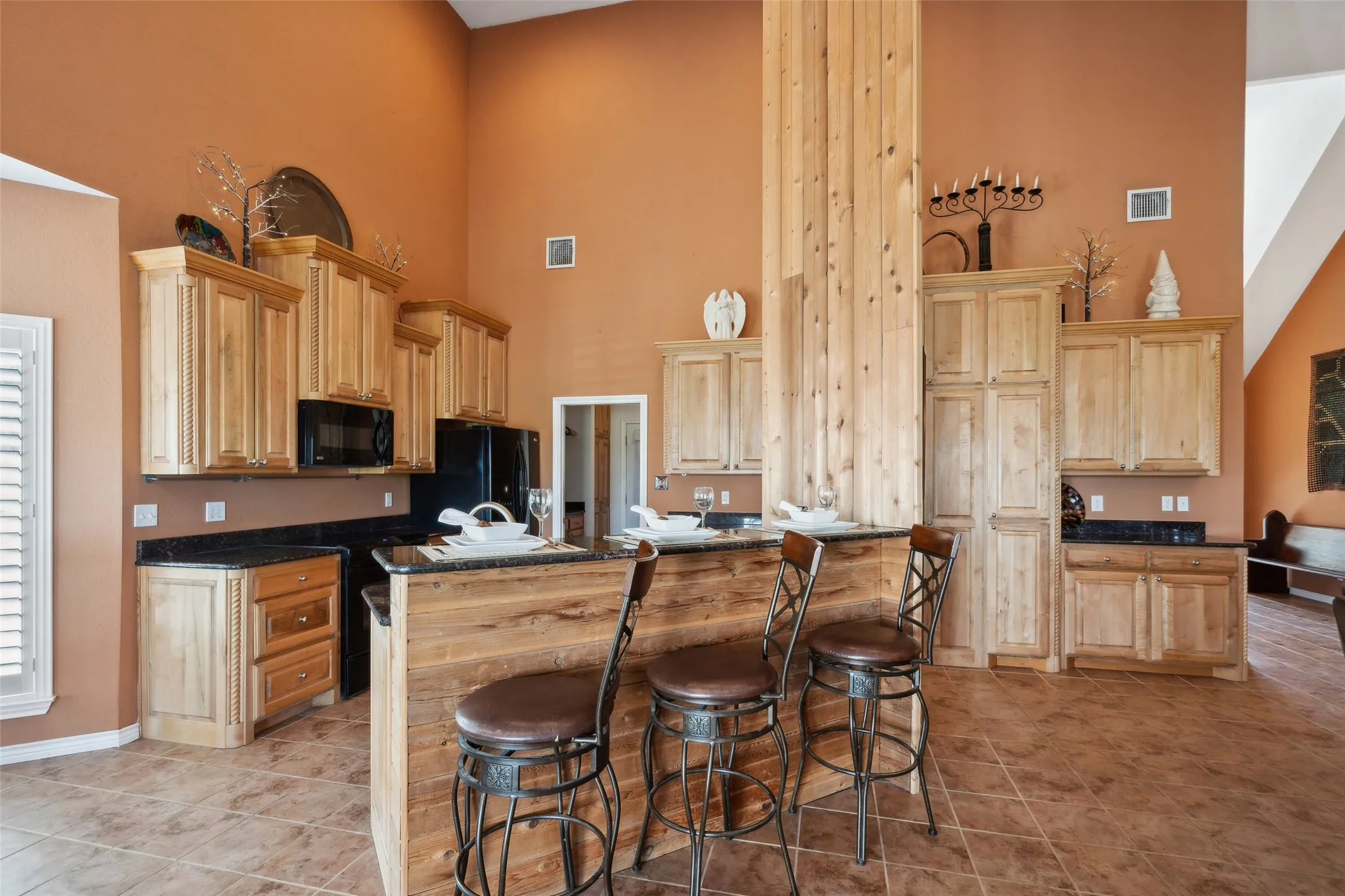 View of the breakfast bar, kitchen and hidden pantry