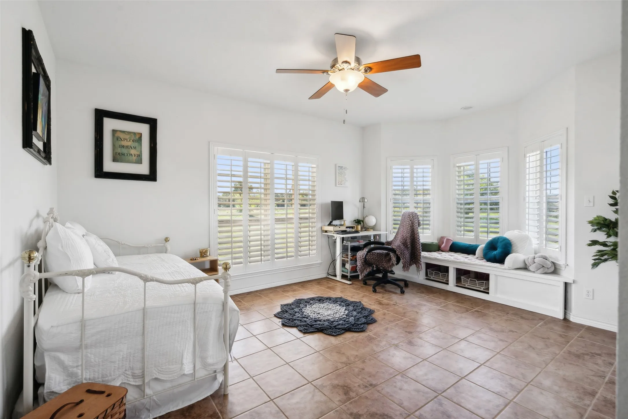 A spacious secondary bedroom with a built-in window seat