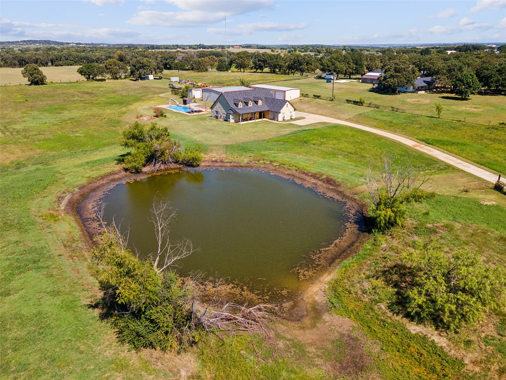 The spring fed pond is perfectly positioned on the 7+ acres