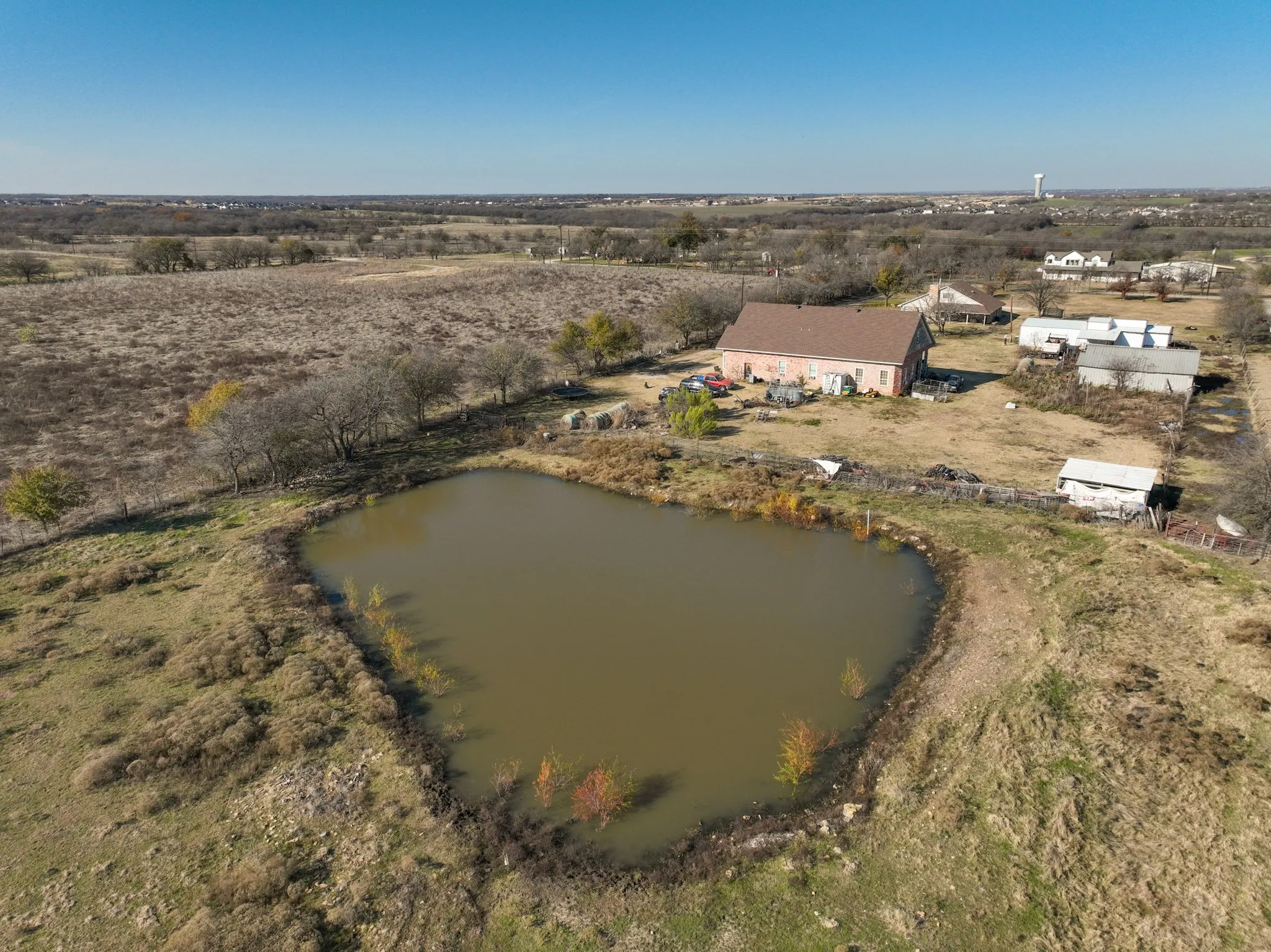 Great investment opportunity with 10 acres, 2 homes, pond, outbuildings, fenced