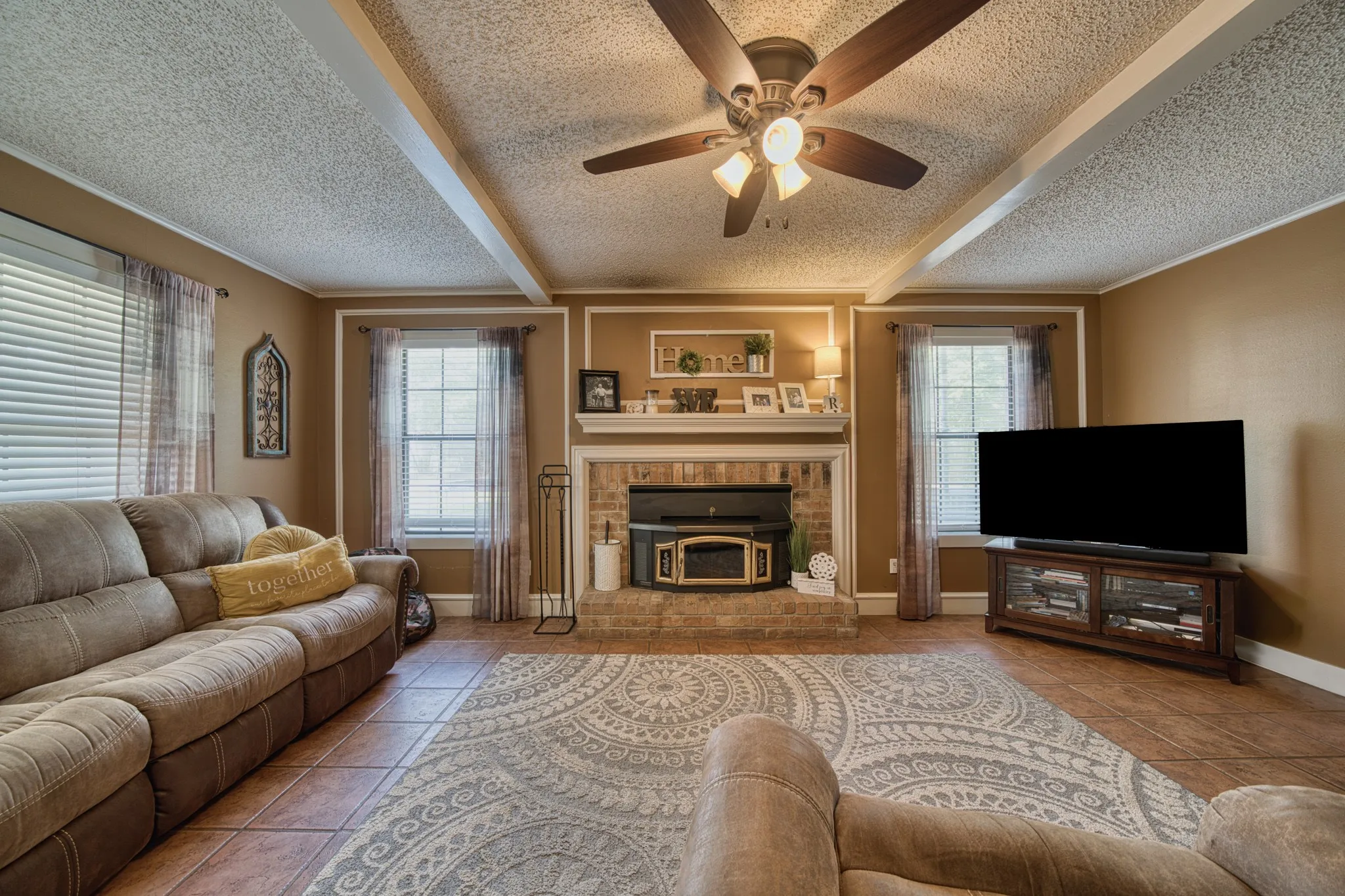 Natural light in living with fireplace & fan