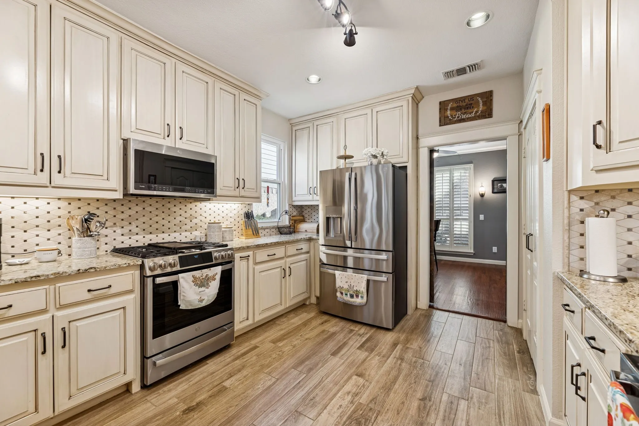 Beautifully redone kitchen with granite counter tops and built in shelves