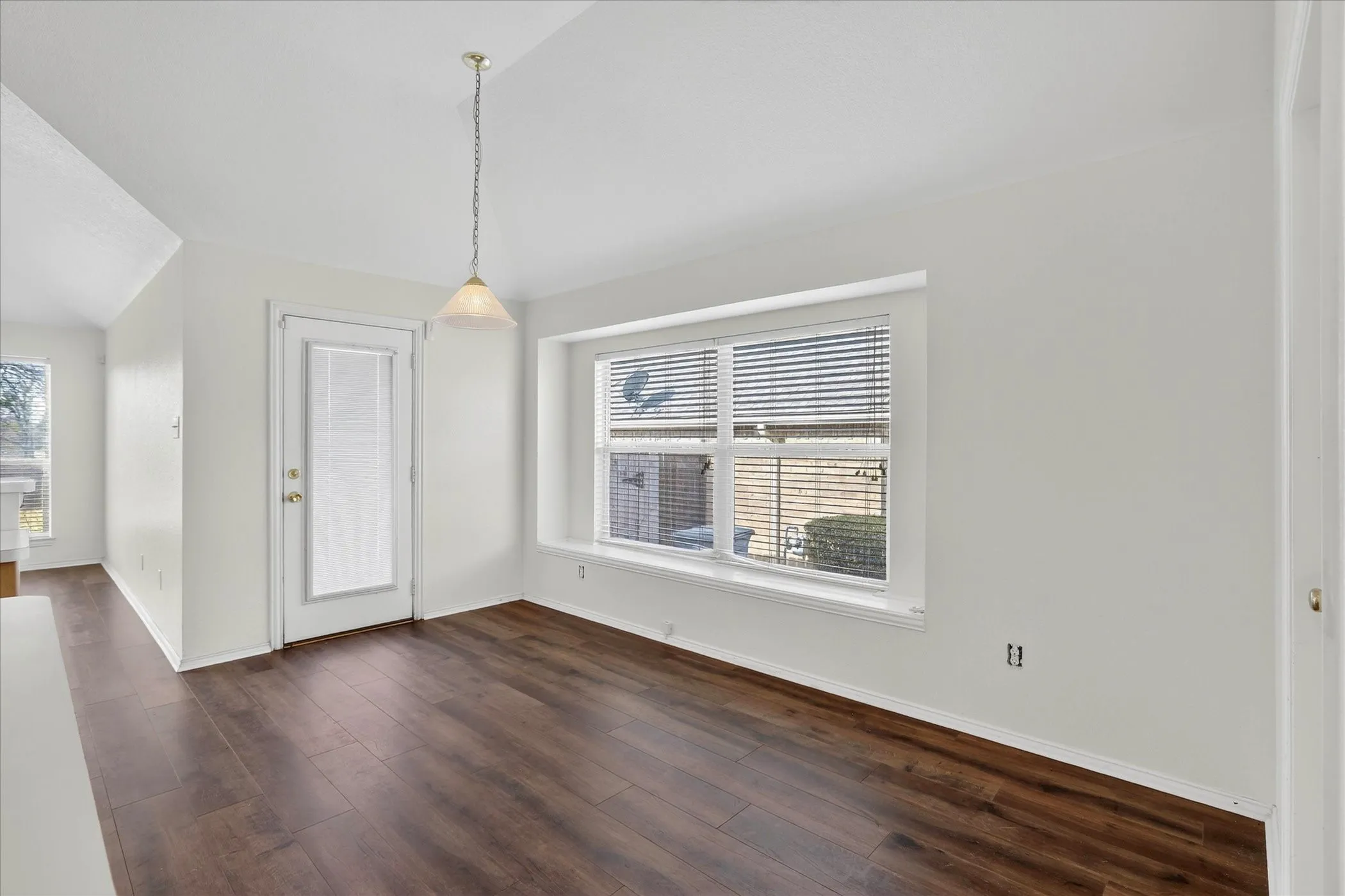 Unfurnished dining area featuring dark wood-style floors