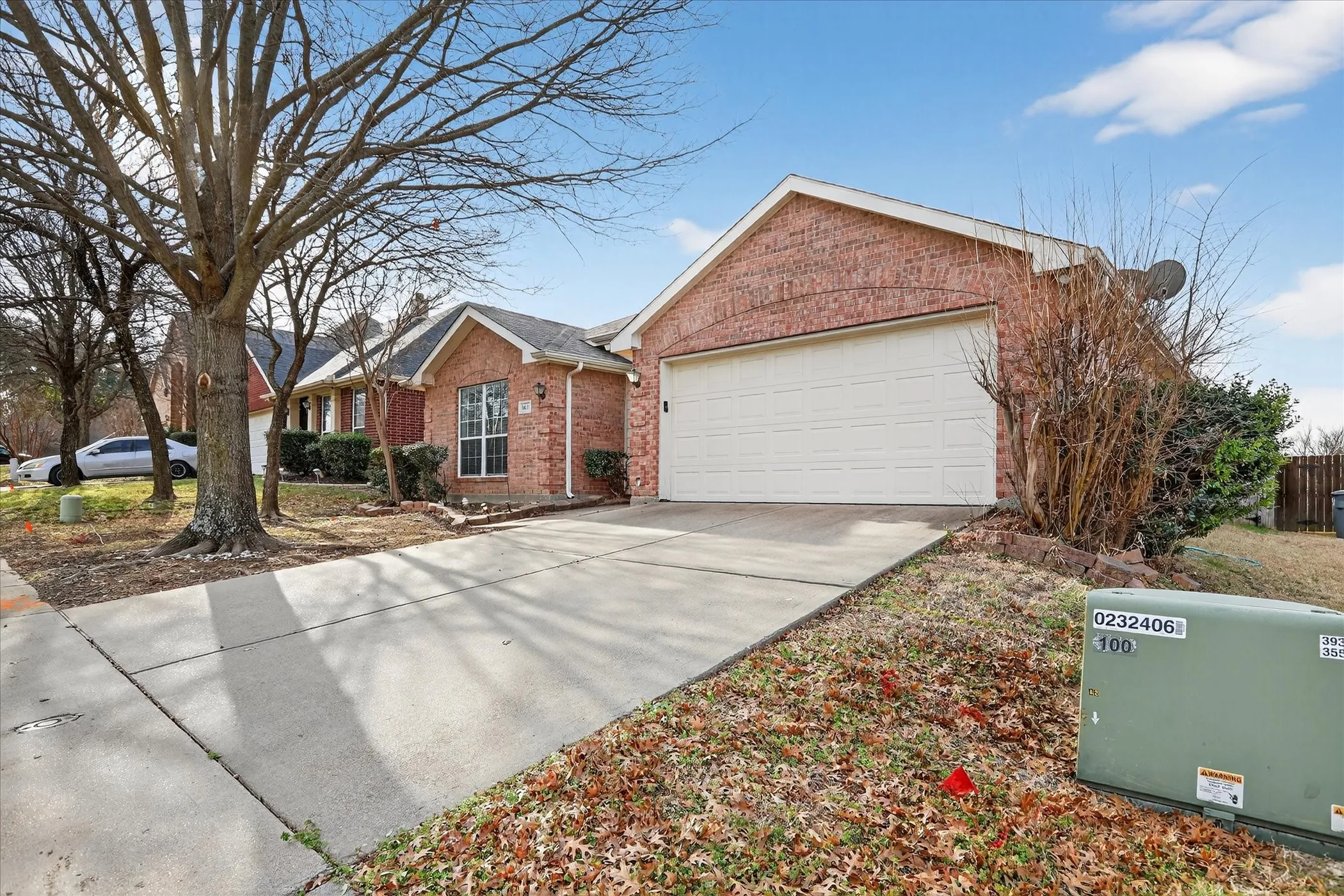 Ranch-style house with brick siding, concrete driveway, and an attached garage