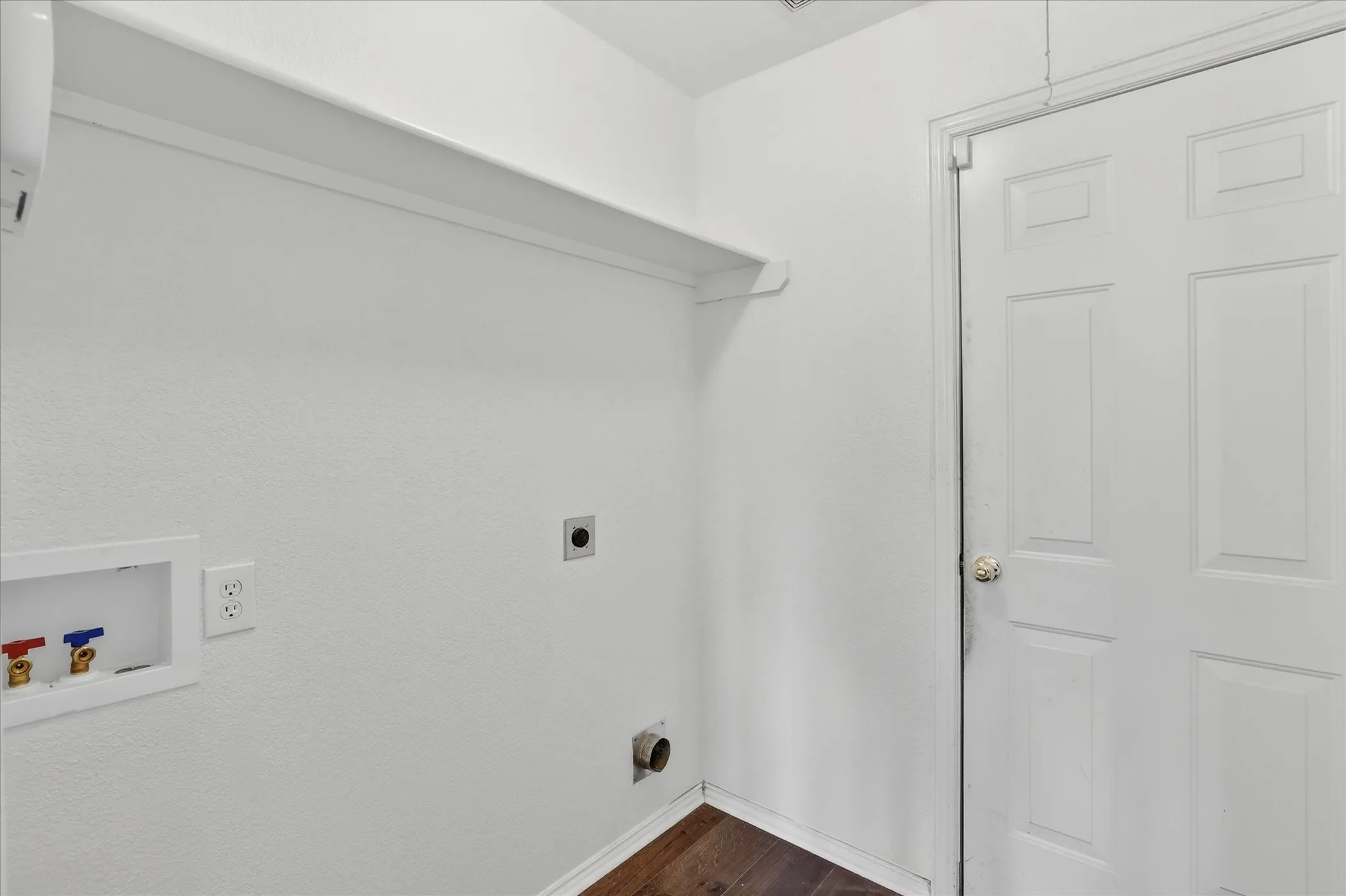 Laundry area with dark wood-style flooring, electric dryer hookup, and washer hookup