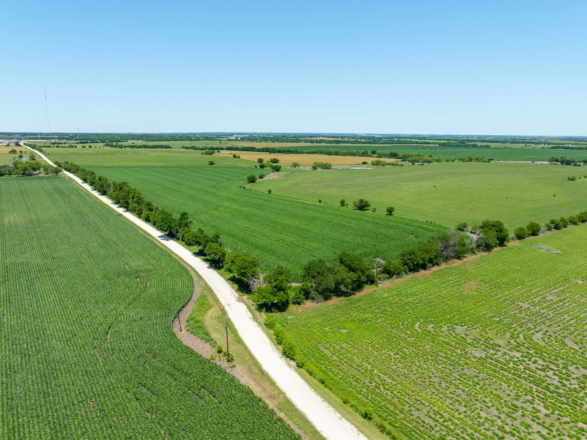 Aerial view of sparsely populated area featuring large plots for crops