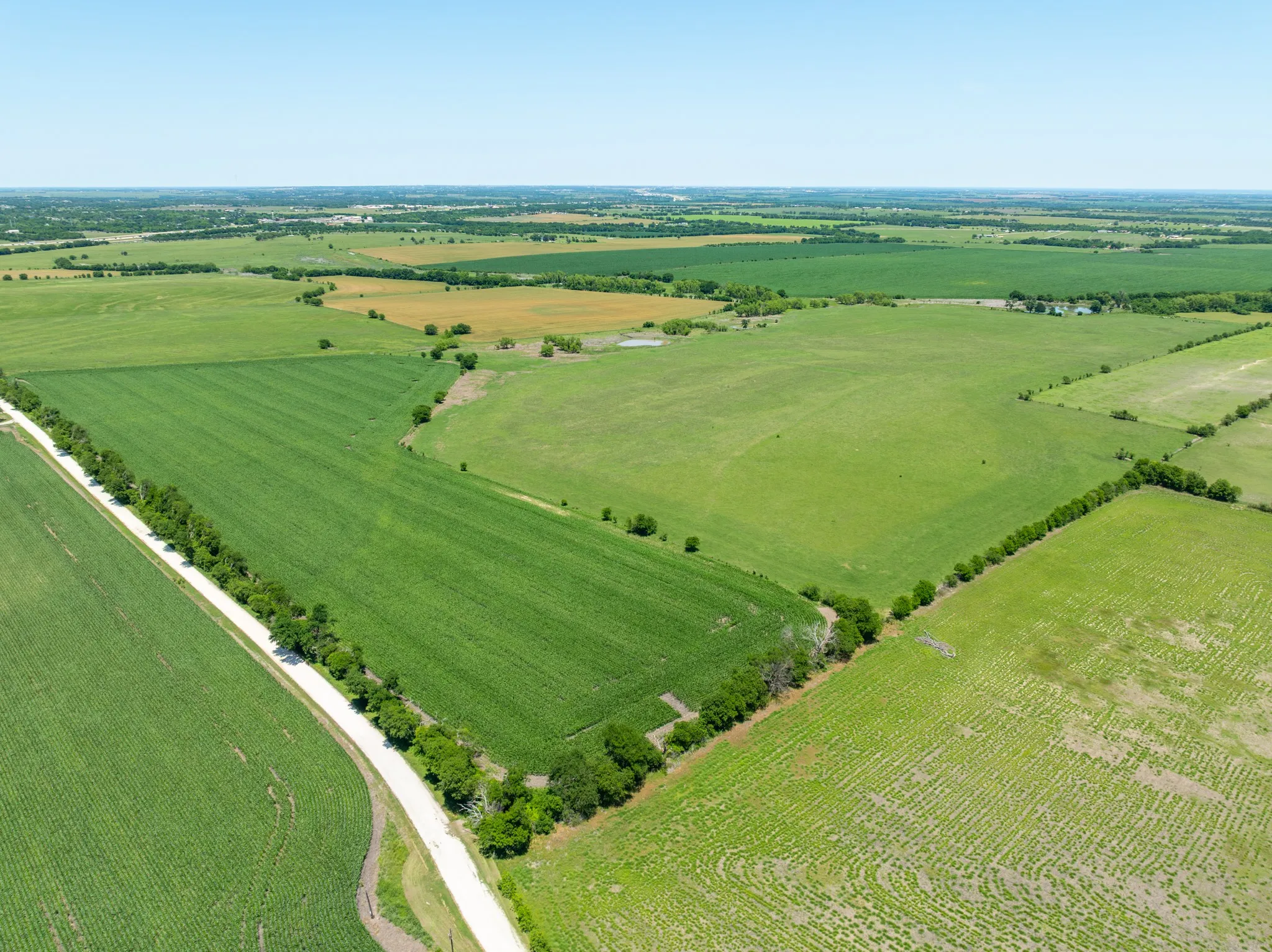 Overview of rural landscape featuring large plots for crops