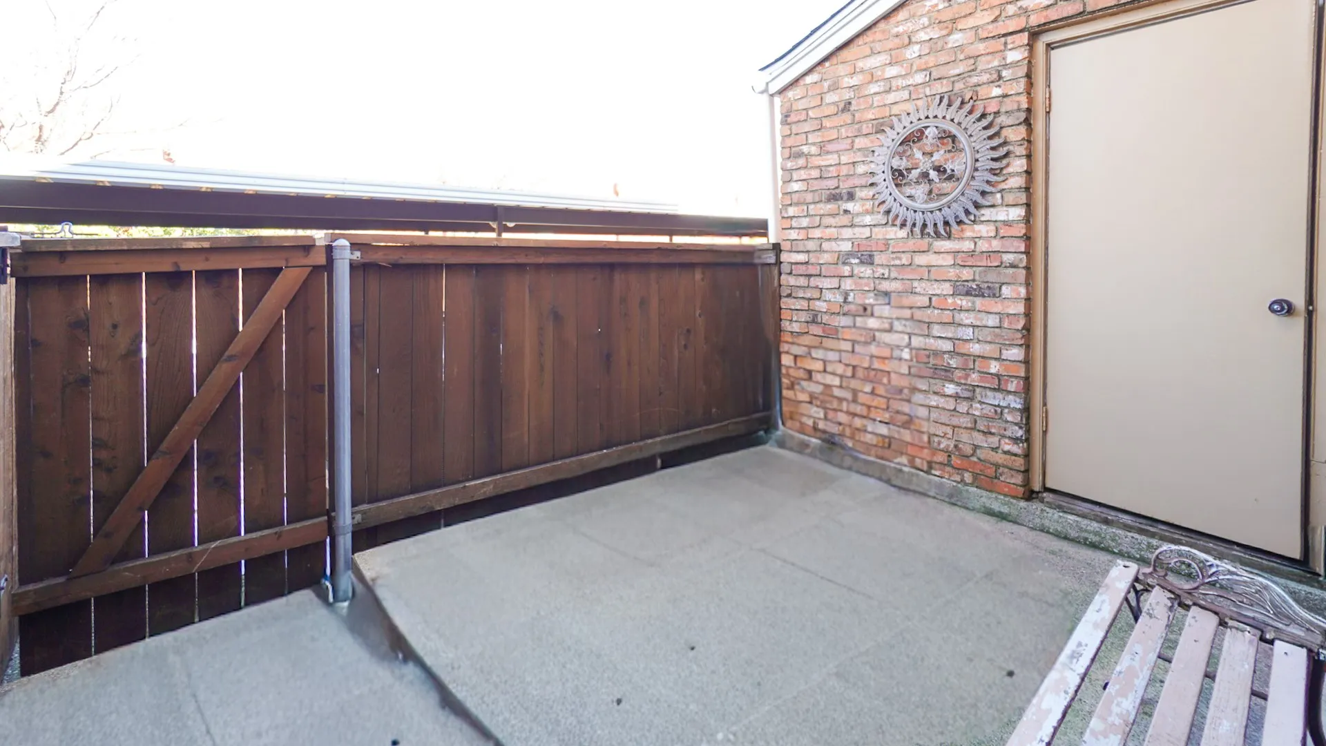 View of patio with a gate