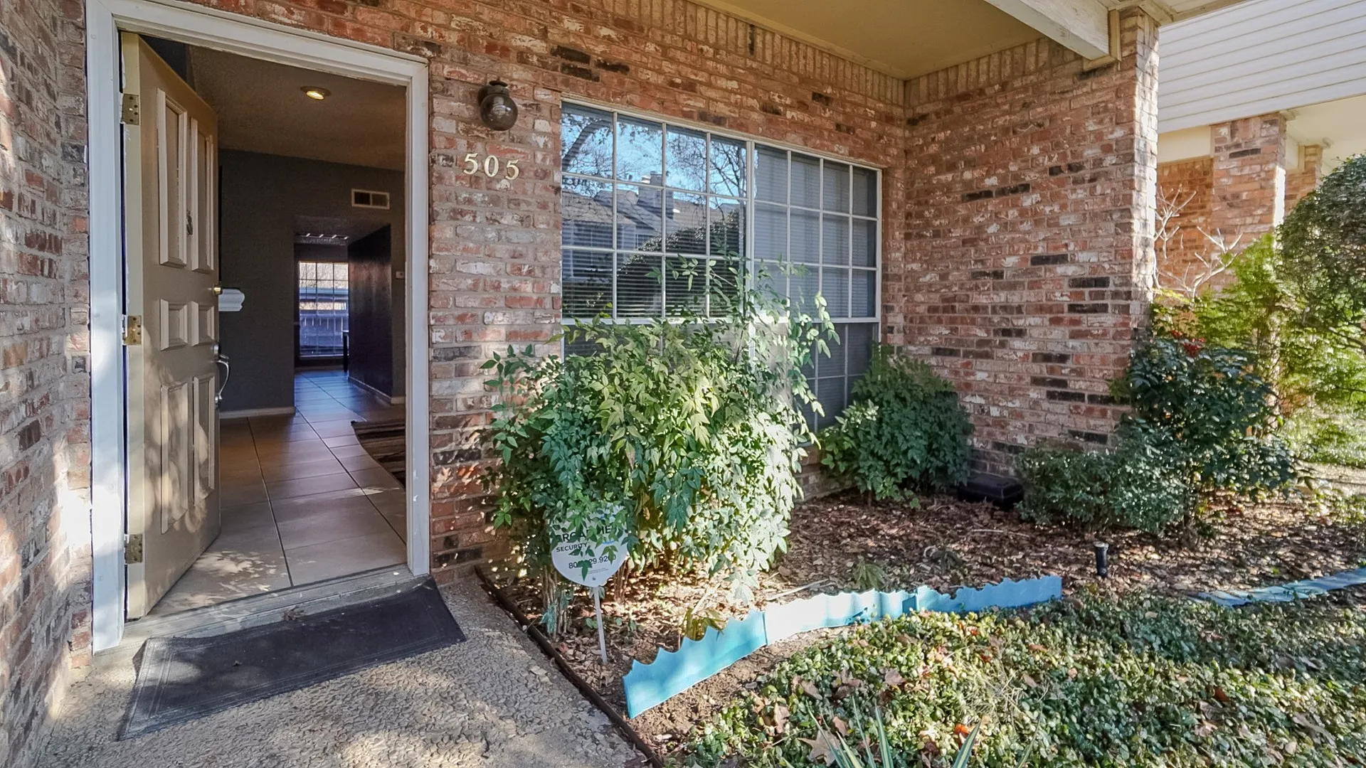 View of exterior entry featuring brick siding